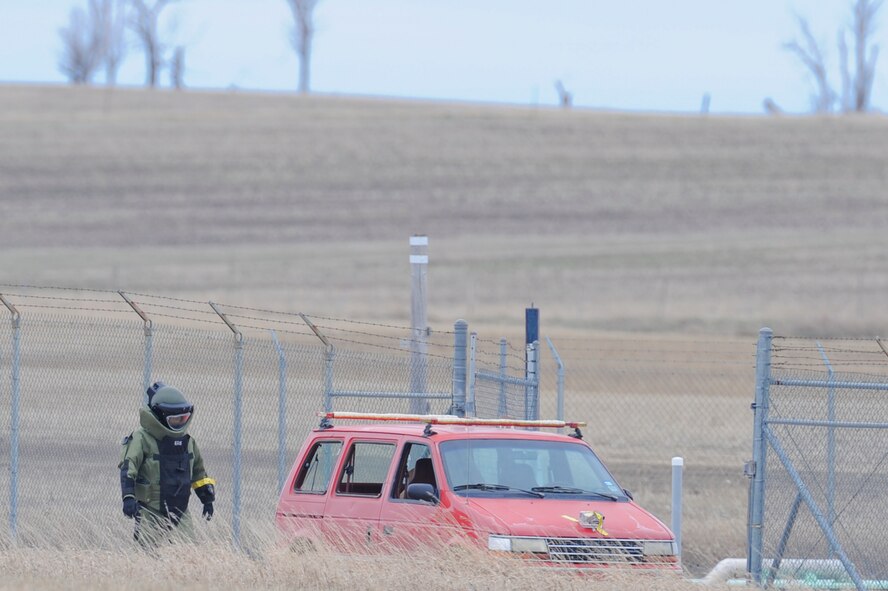NEAR PARSHALL, N.D. – A member of the 5th Civil Engineer Squadron’s Explosive Ordnance Disposal team finishes placing a charge on a protestor’s vehicle at the H-08 Minuteman III launch facility near Parshall, N.D., April 15. The EOD team was part of coordinated actions from the 91st Missile Wing and the 5th Bomb Wing after Security Forces determined a man had crawled over the fence of the LF as a sign of protest. (U.S. Air Force photo by Staff Sgt. Keith Ballard)