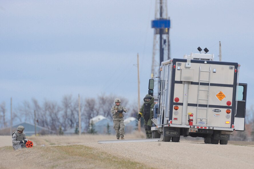 NEAR PARSHALL, N.D. – Members of the 5th Civil Engineer Squadron’s Explosive Ordnance Disposal team prepare to set off a charge placed on a protestor’s vehicle at the H-08 Minuteman III launch facility near Parshall, N.D., April 15. The EOD team was part of coordinated actions from the 91st Missile Wing and the 5th Bomb Wing after Security Forces determined a man had crawled over the fence of the LF as a sign of protest. (U.S. Air Force photo by Staff Sgt. Keith Ballard)