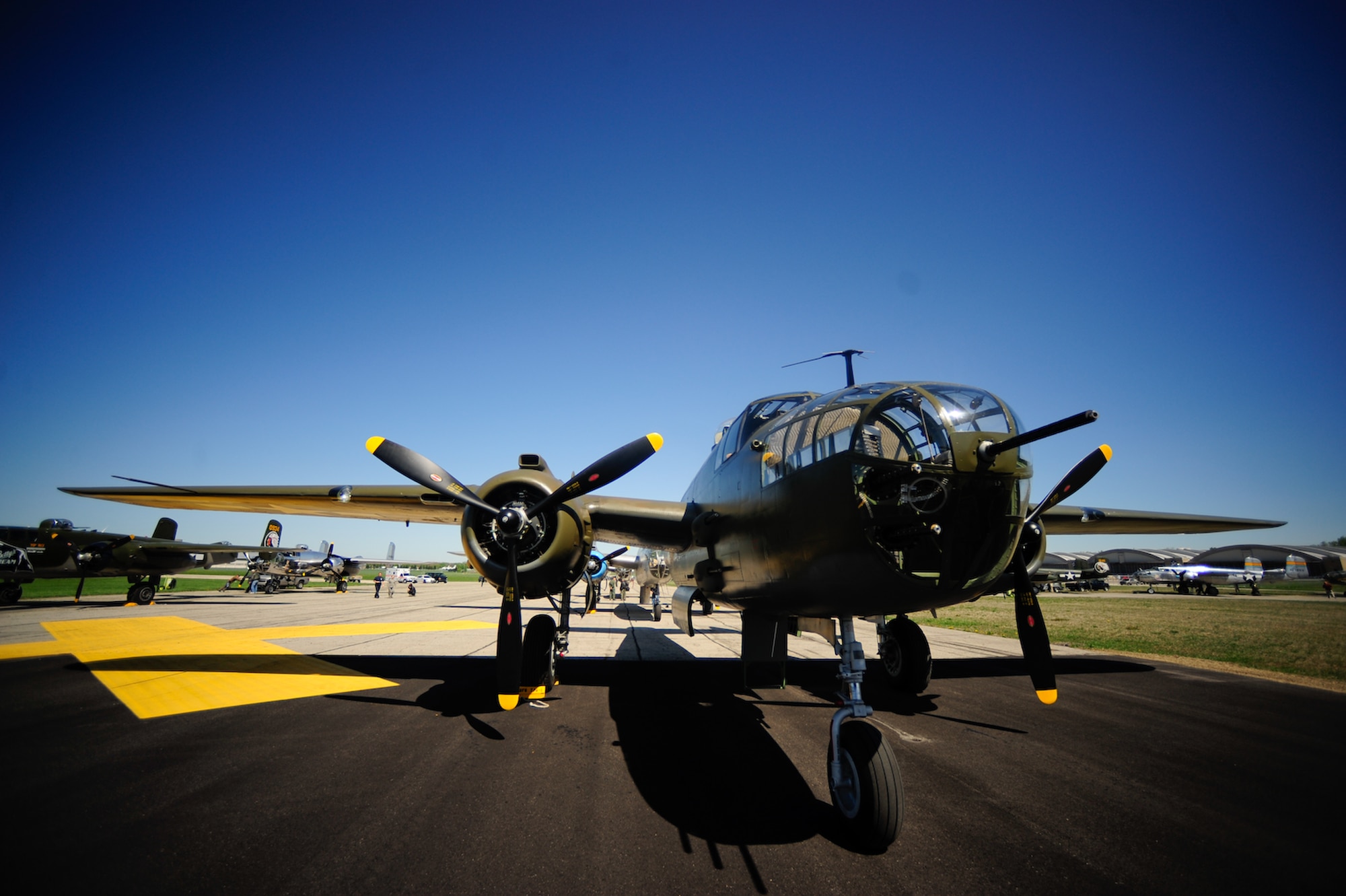 Vintage B-25 Mitchell bombers stand ready to start engines and take off from the National Museum of the U.S. Air Force at Wright-Patterson Air Force Base, Ohio.  They will join a 17-ship formation to take part in a memorial flight honoring the Doolittle Tokyo Raiders on April 18, 2010.  The 68th Doolittle Raiders' reunion commemorates the anniversary of the raid on April 18, 1942, by U.S. Army Air Forces Lt. Col. Jimmy Doolittle's squadron of 16 B-25 Mitchell bombers. The raid onTokyo was in response to Japan's attack on Pearl Harbor. (U.S. Air Force photo/Tech. Sgt. Jacob N. Bailey)

