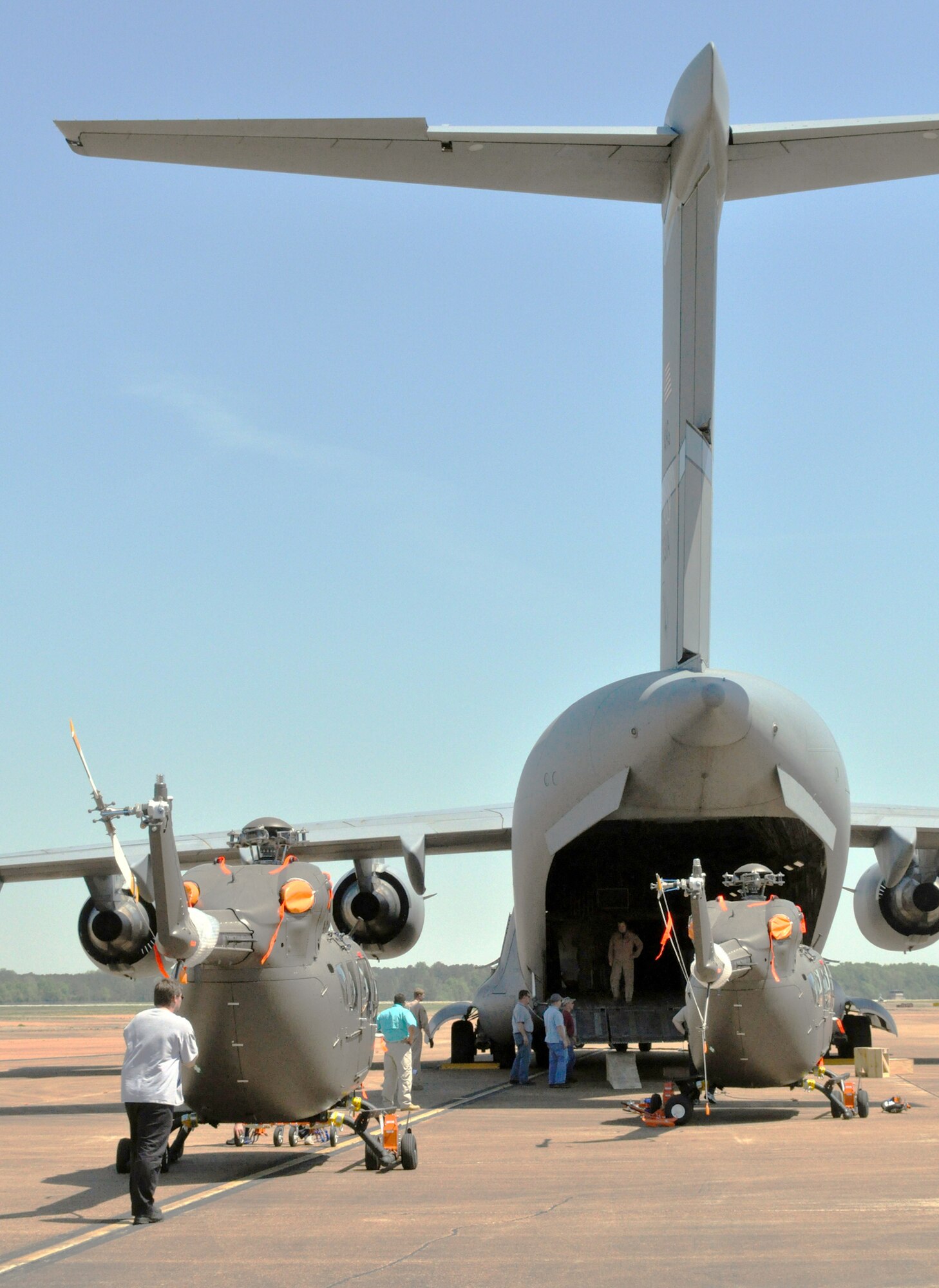 UH-72 Lakota light utility helicopters are assembled behind a C-17 Globemaster III in preparation for transport April 12, 2010, at  Columbus Air Force Base, Miss. (U.S. Air Force photo/Senior Airman Jacob Corbin)