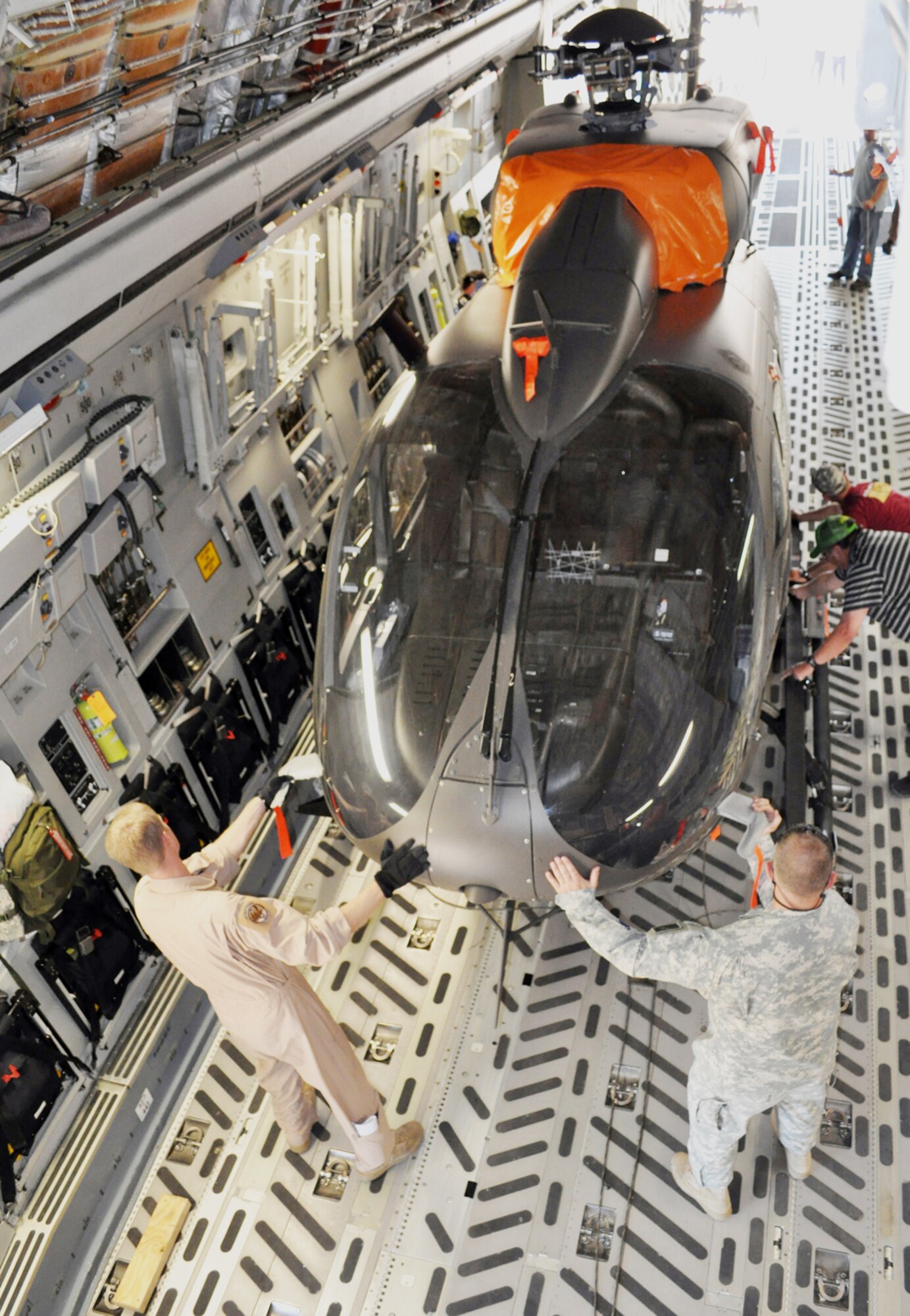 Army Chief Warrant Officer Five John Jones and Tech. Sgt. Charles Boulton help guide a UH-72 Lakota light utility helicopter into a C-17 Globemaster III April 12, 2010, at Columbus Air Force Base, Miss. Chief Warrant Officer Jones is a Army light utility helicopter program acceptance pilot and Sergeant Boulton is a C-17 loadmaster assigned to the 172nd Airlift Wing. (U.S. Air Force photo/Senior Airman Jacob Corbin)