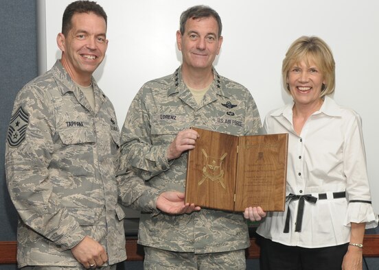 RANDOLPH AIR FORCE BASE, Texas -- Air Education and Training Command Command Chief Rob Tappana presents Gen. Stephen R. Lorenz with a formal invitation April 14 to the Order of the Sword induction ceremony scheduled for July 16 on Lackland Air Force Base in his honor. The general’s wife, Leslie Lorenz, accompanies him during the presentation. (U.S. Air Force photo/Joel Martinez) 