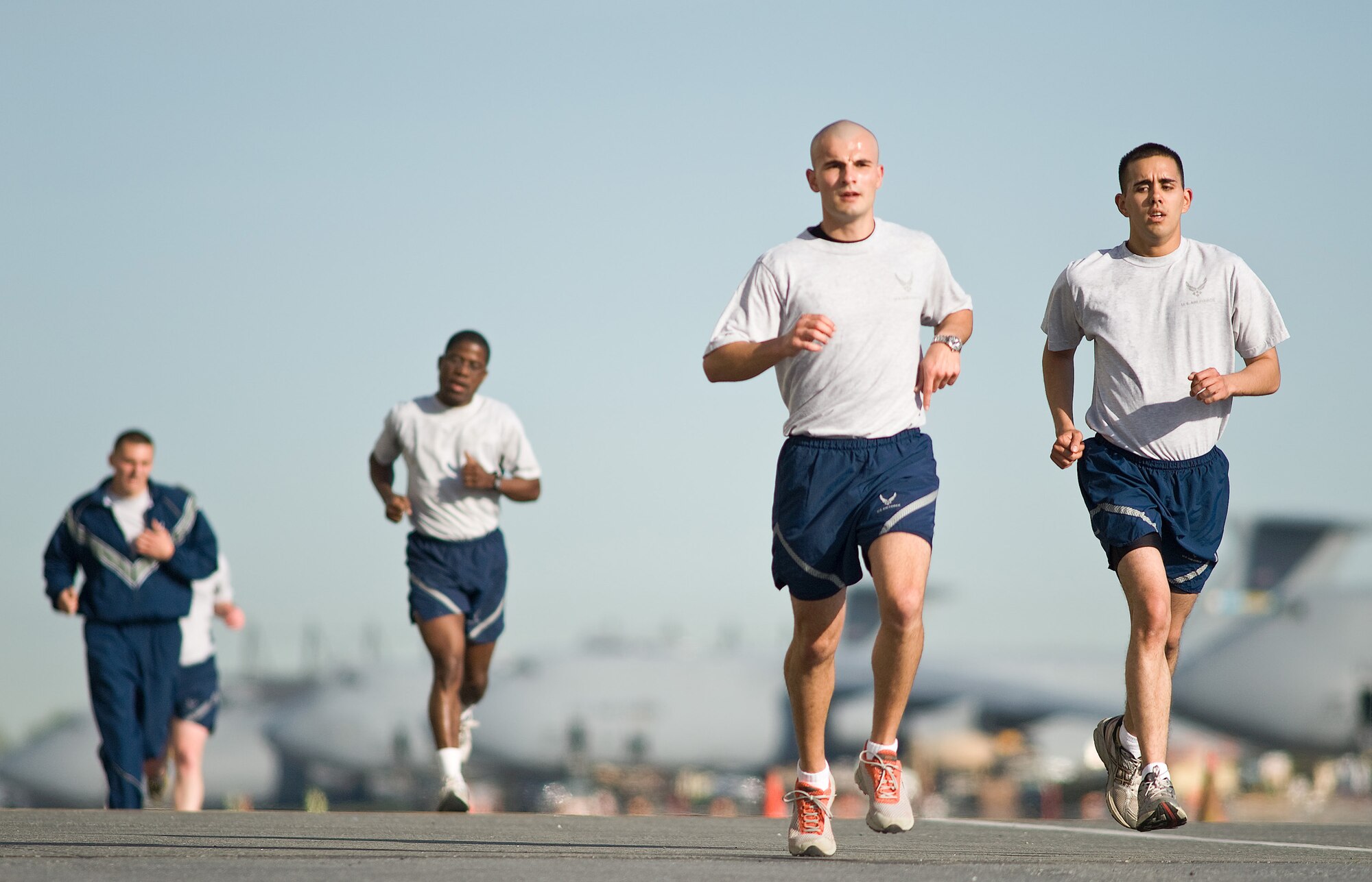 Team Dover members run on the flightline during the Warrior Run April 20. Warrior Runs are held monthly to build morale and emphasize fitness. (U.S. Air Force photo/ Roland Balik)