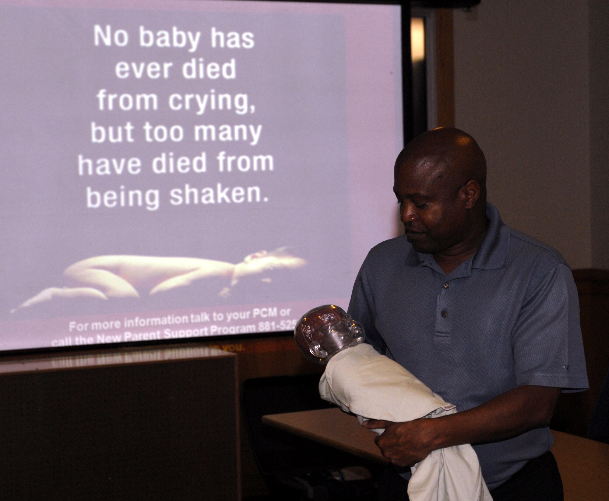 Gary Scott, a Family Advocacy Program assistant with the 1st Special Operations Medical Operations Squadron, holds up an electronic baby mannequin to demonstrate the effects of shaken baby syndrome during the "Dads: The Basics" class at the Hurlburt Field Airman & Family Readiness Center April 14. The program was created by the non-profit National Center for Baby Shaken Syndrome to educate men about the dangers of shaking to help them learn the skills they need to care for infants and encourage discussion among the participants about their own perceptions of fatherhood. (DoD photo by U.S. Air Force Airman 1st Class Joe McFadden) (RELEASED)
