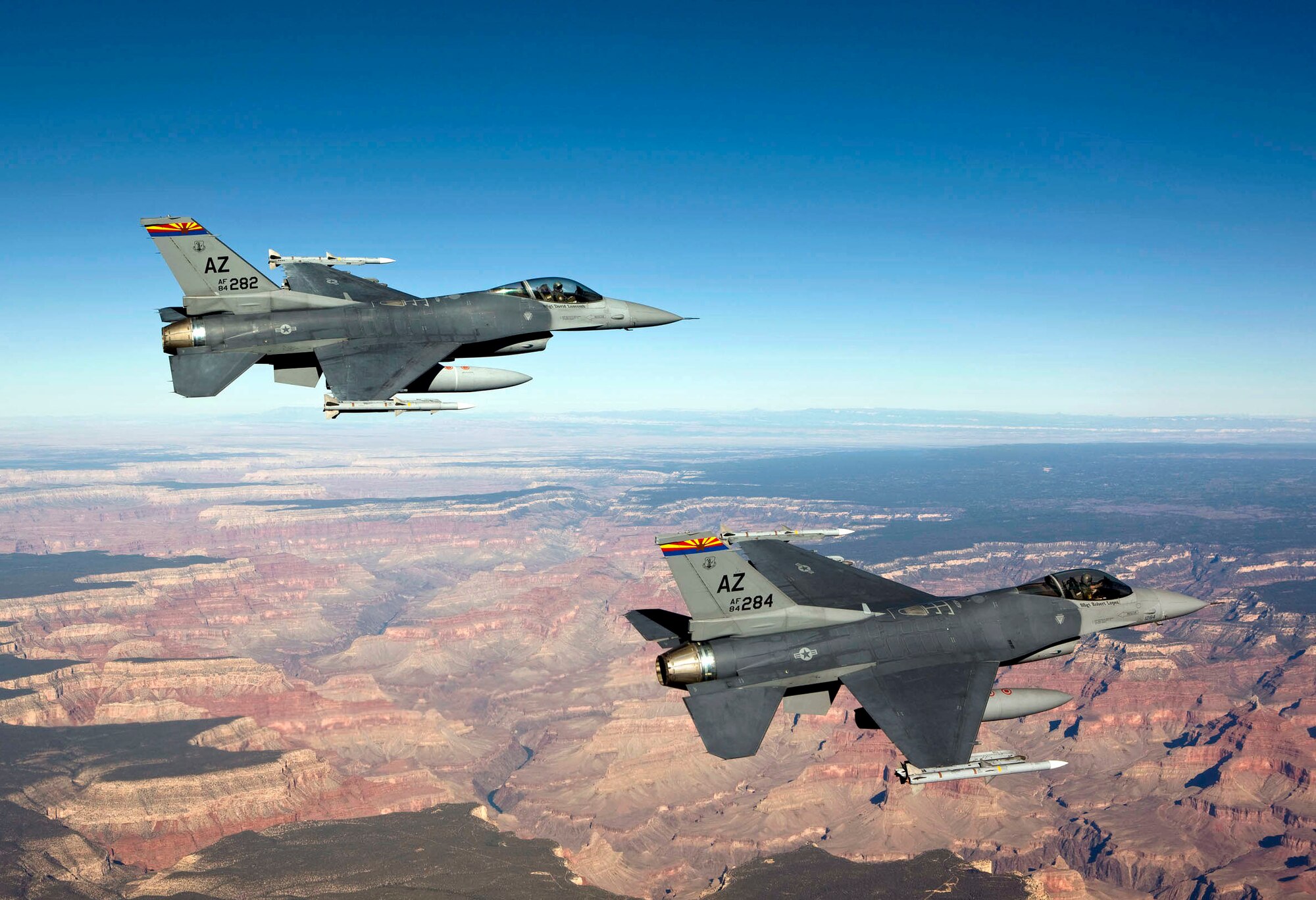 Capt. Bob Peel, left, and Lt. Col. Tony Adamo, right, F-16 instructor pilots from the 162nd Fighter Wing, fly over the Grand Canyon while supporting Operation Noble Eagle’s air sovereignty alert mission. The Arizona Air National Guard alert unit recently earned the 2009 Air Sovereignty Alert Unit of the Year award. (Photo by James Haseltine, High-G Productions)