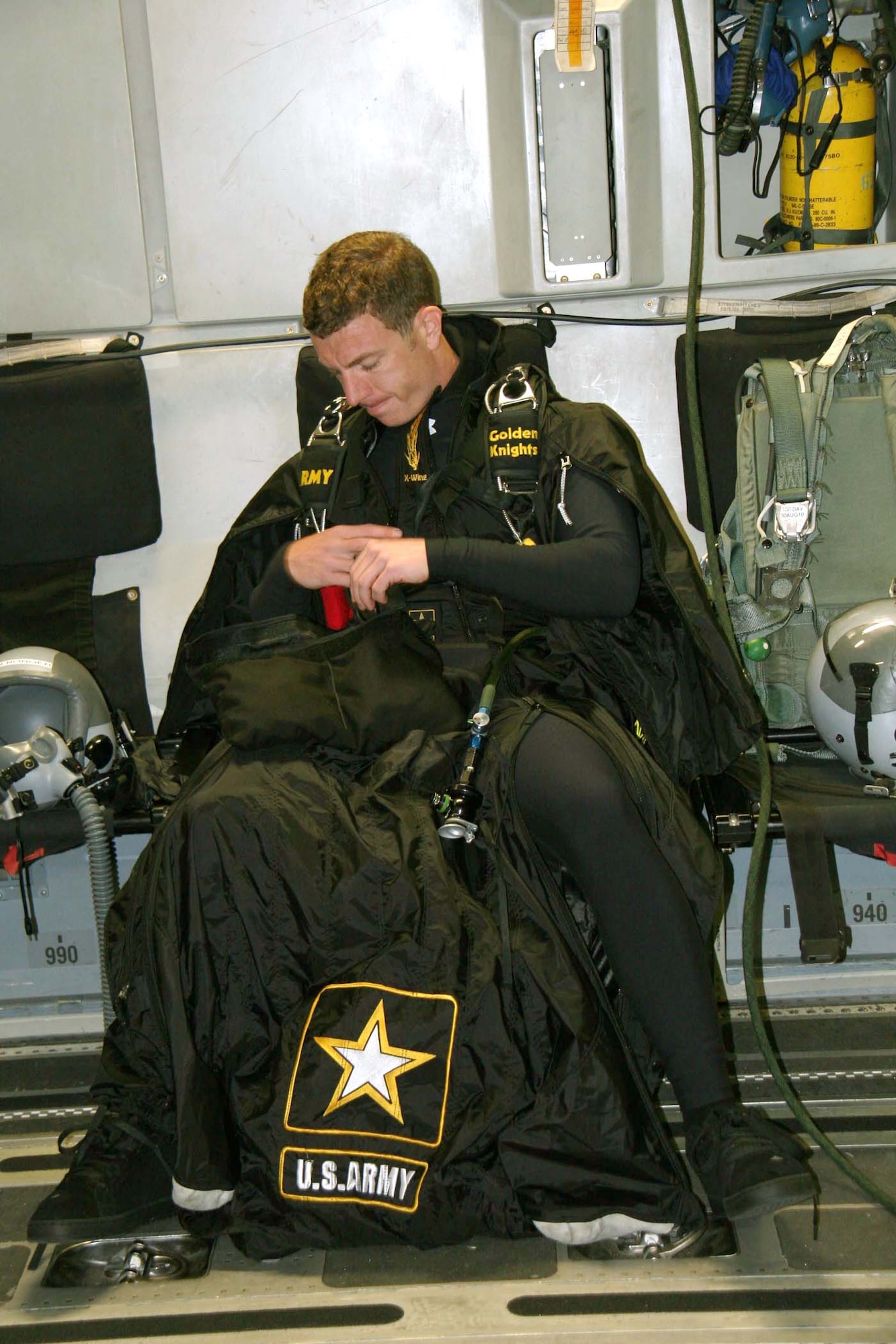 Army Staff Sgt. Ben Borger, of the Army parachute team the Golden Knights checks over his wing-suit before attempting to set a new world wing-suit distance record April 14, 2010, over Altus Air Force Base, Okla. (U.S. Army photo)