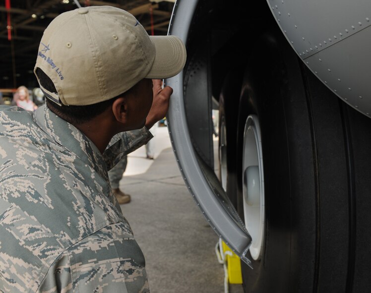 MARIETTA, Ga. -- Senior Airman Michael Jones, 723rd Aircraft Maintenance Squadron C-130P crew chief, looks over the new HC-130J Super Hercules aircraft during the unveiling ceremony here April 19. The new aircraft features quality of life improvements for aircrews including flushable toilets, improved air conditioning and a microwave. (U.S. Air Force photo by Airman 1st Class Benjamin Wiseman/RELEASED)