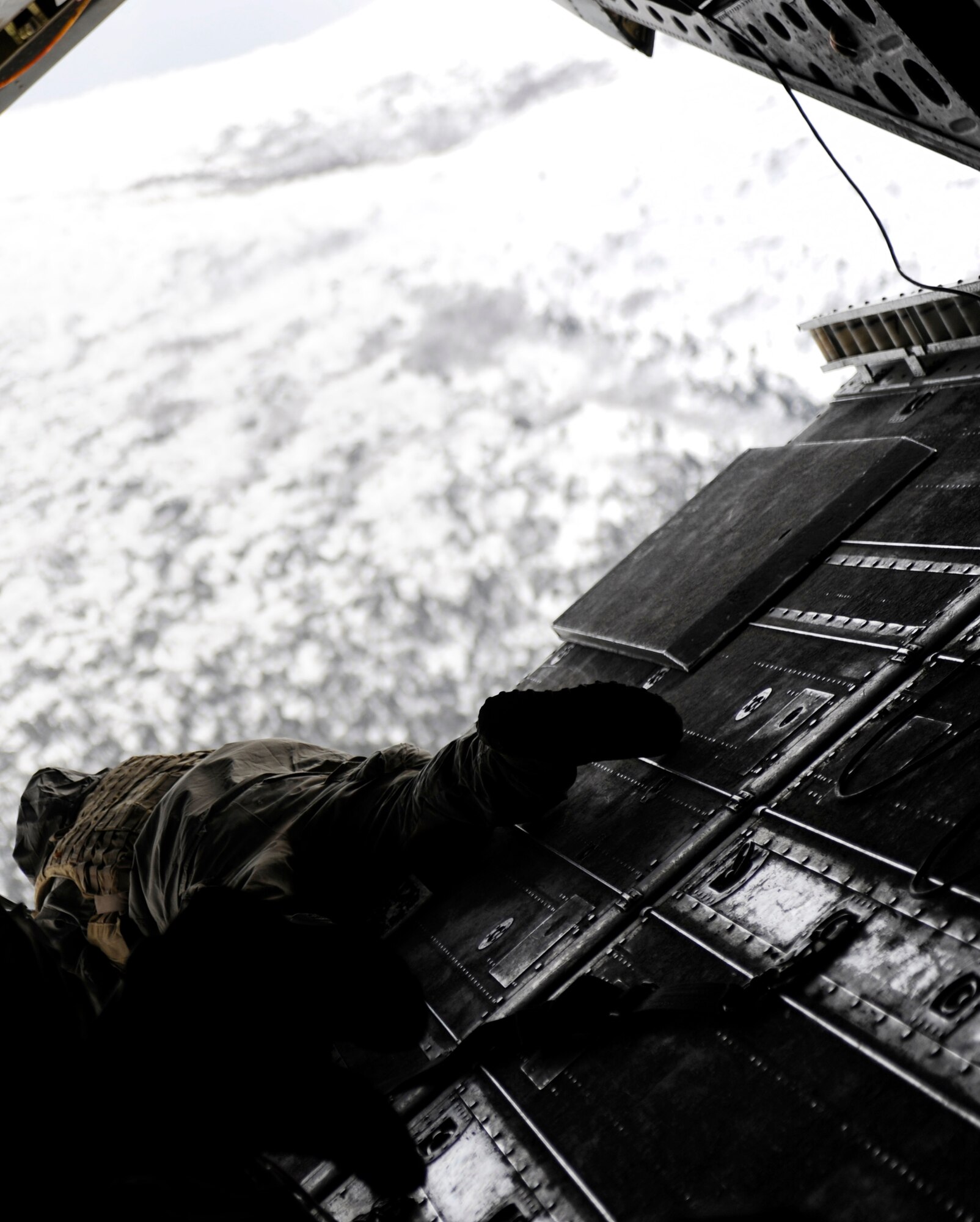 A special operations weather team operator looks out the back of a CH-47 Chinook to locate a landing site during an operational training exercise April 15, 2010, Eielson Air Force Base, Alaska. The exercise was part of Red Flag-Alaska 10-2 and enables units to sharpen their combat skills by exchanging tactics, techniques, and procedures and improves interoperability. (U.S. Air Force photo/Airman 1st Class Willard E. Grande II)