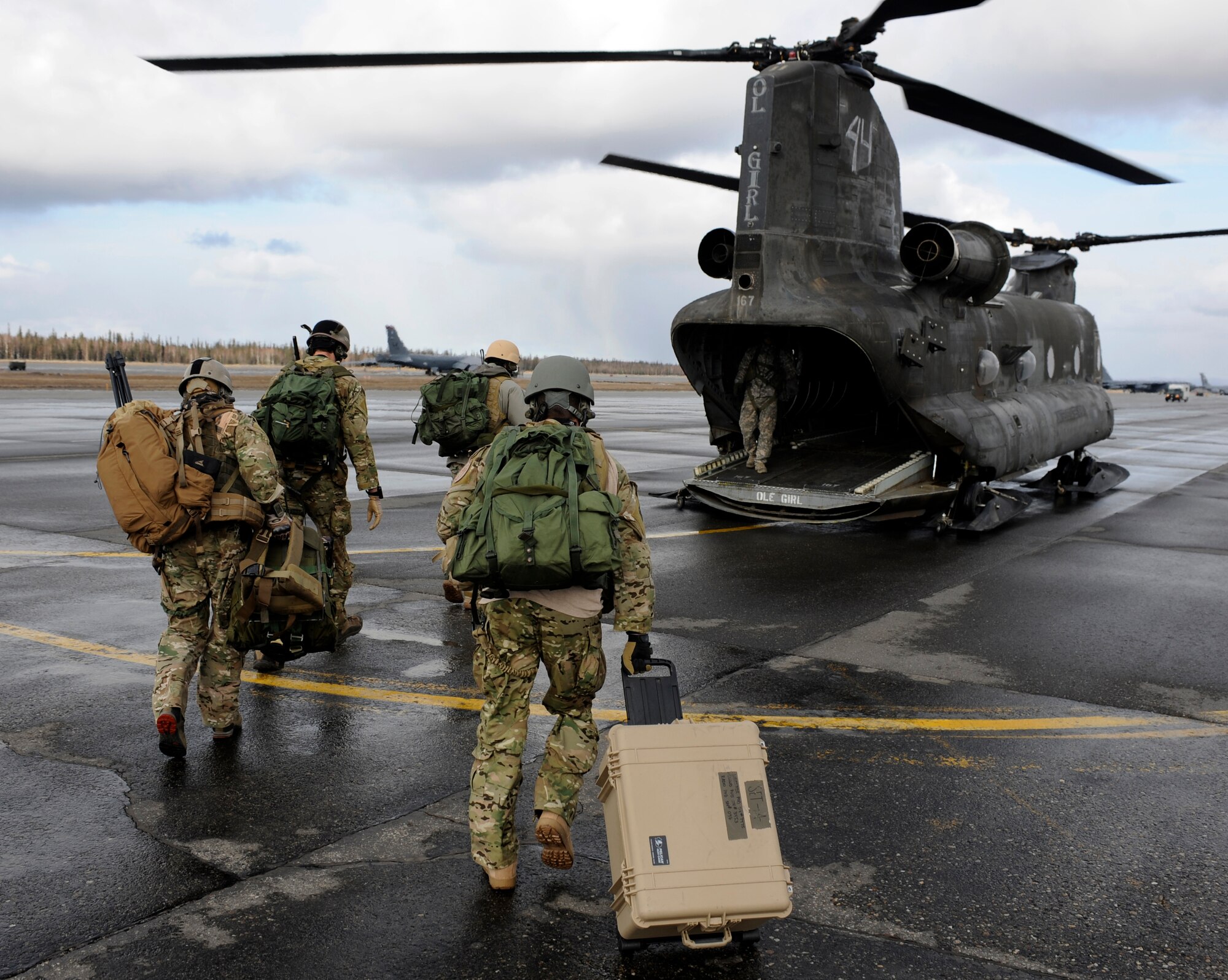 A team of special operations weather team operators hurry to board a CH-47 Chinook during a training operation for Red Flag-Alaska 10-2 April 15, 2010, Eielson Air Force Base, Alaska. The operators are deploying weather pods that will take several different types of readings that could affect air and ground operations down range. (U.S. Air Force photo/Airman 1st Class Willard E. Grande II)