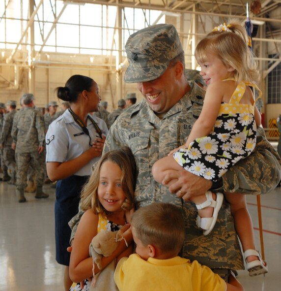 LUKE AIR FORCE BASE, Ariz. -- Lt. Col. Matthew Willis, former 56th Operations Support Squadron commander, celebrates with his children after relinquishing command to Lt. Col. William Jones, 56th Operations Support Squadron commander, during the change-of-command ceremony March 2, 2009.  (U.S. Air Force photo/Airman 1st Class Ronifel Yasay)