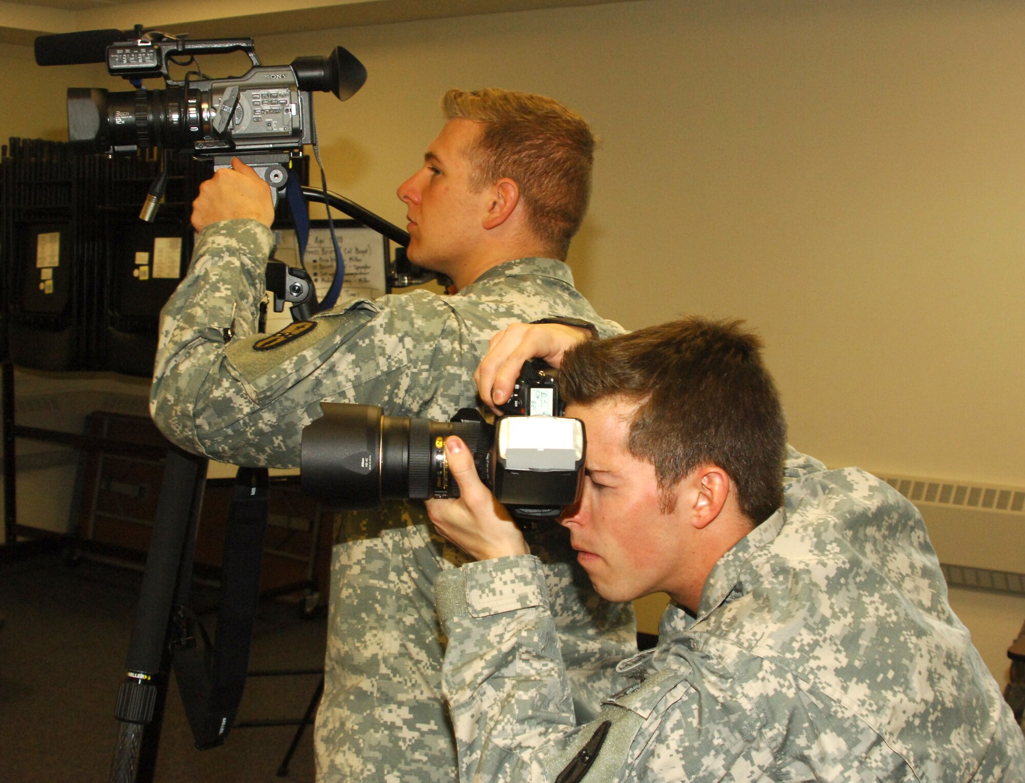 Staff Sgt. Nicholas Pavlik and Staff Sgt. Randall Carey act as cameramen during a mock press conference training exercise here April 2.These Soldiers are in the 196th Mobile Public Affairs Detachment, training with their fellow brethren for an upcoming mission in Balad, Iraq. The 196th MPAD is an Army National Guard unit from Columbus, Ohio. (U.S. Army photo/Ryan Morton)