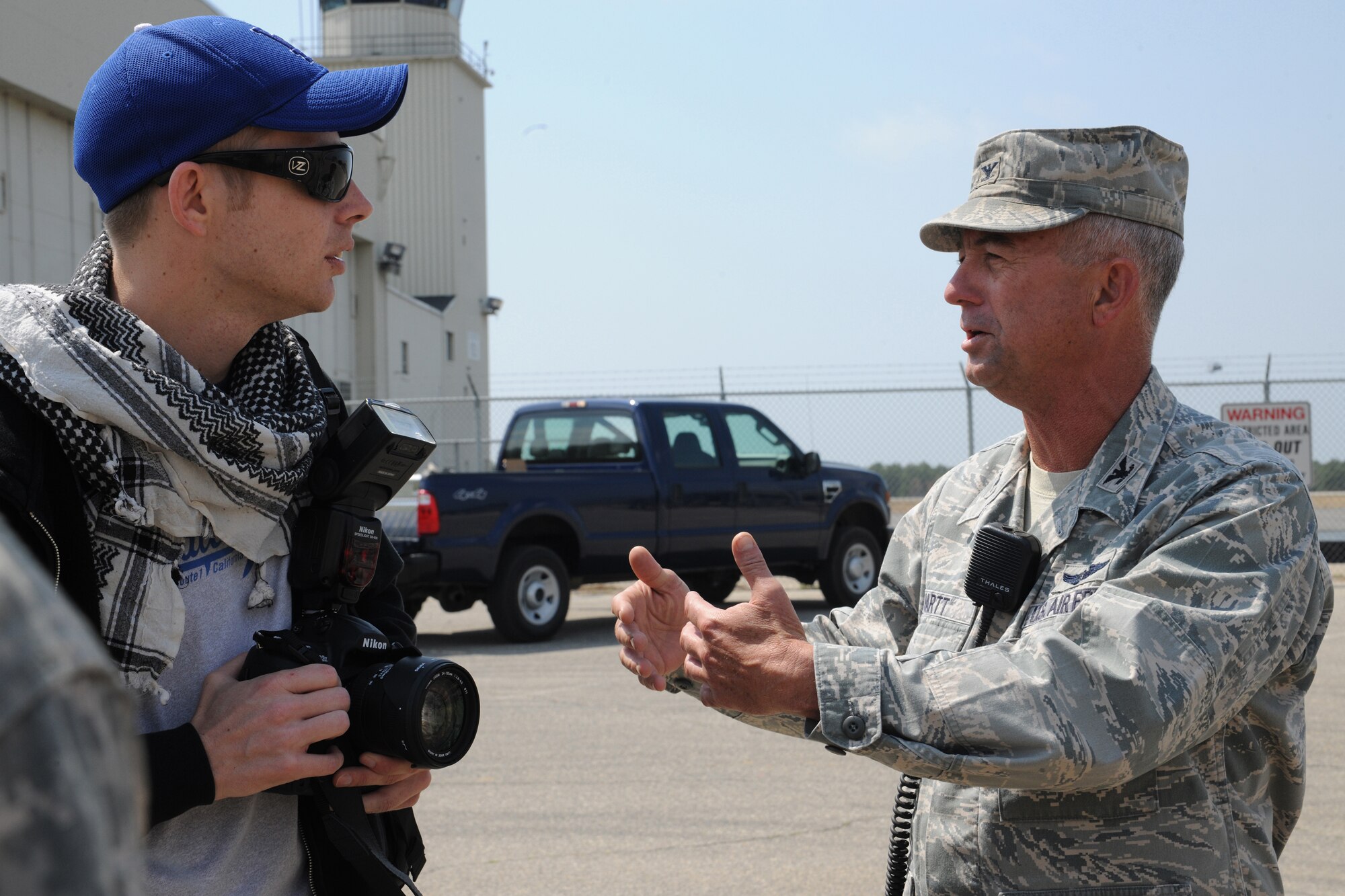 Staff Sgt. Zachary Wilson, U.S. Air Force Expeditionary Center public affairs, role-plays as the host-nation media while interviewing Col. Quintin Hartt, 572nd Contingency Response Group commander, during Exercise Eagle Flag April 16 here. Eagle Flag utilizes role players to provide realistic interaction and involvement as host-nation civilians and government and military officials. (U.S. Air Force Photo/Staff Sgt. Nathan G. Bevier)