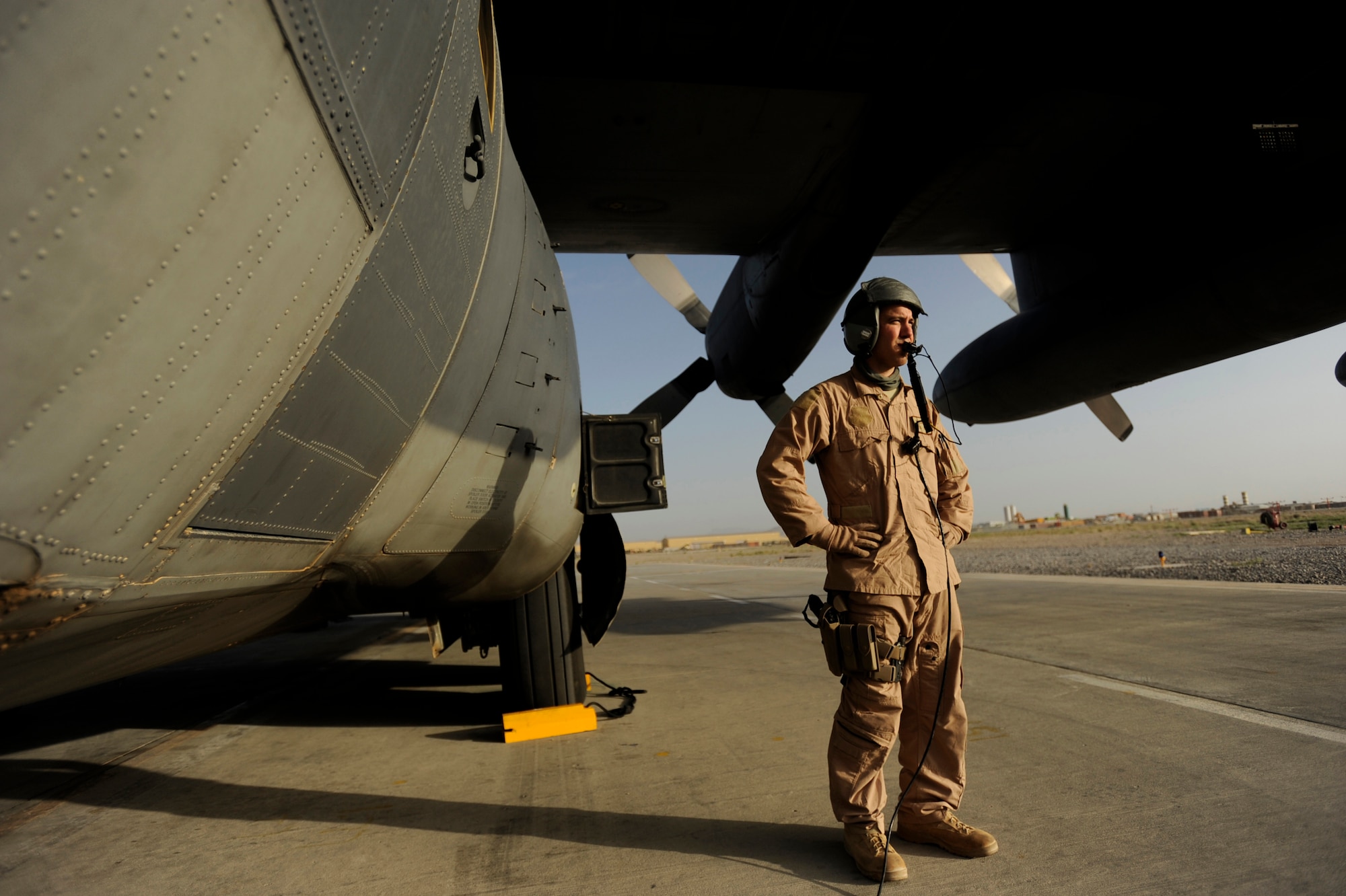 Senior Airman J.C. Wardean, an HC-130P Hercules loadmaster assigned to the 79th Expeditionary Rescue Squadron, waits for a fuel truck to refuel an HC-130P aircraft, April 17, 2010, Kandahar Airfield, Afghanistan. (U.S. Air Force photo/Staff Sgt. Manuel J. Martinez/released)