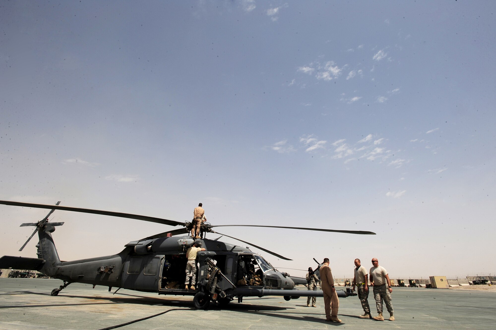Aircraft maintenance Airmen assigned to the 451st Expeditionary Aircraft Maintenance Squadron helicopter maintenance unit and an HH-60 Pave Hawk flight engineer assigned to the 41st Expeditionary Rescue Squadron perform minor maintenance on a Pave Hawk after the aircrew returned from a medical-evacuation mission April 16, 2010, at Camp Bastion, Afghanistan. (U.S. Air Force photo/Staff Sgt. Manuel J. Martinez)