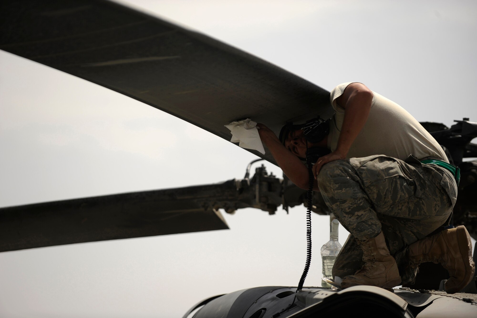 Senior Airman Robert Fabela cleans the rotors of an HH-60 Pave Hawk after the aircrew returned from an alert mission April 16, 2010, at Camp Bastion, Afghanistan. Airman Fabela is a Pave Hawk crew chief assigned to the 451st Expeditionary Aircraft Maintenance Squadron helicopter maintenance unit. (U.S. Air Force photo/Staff Sgt. Manuel J. Martinez)