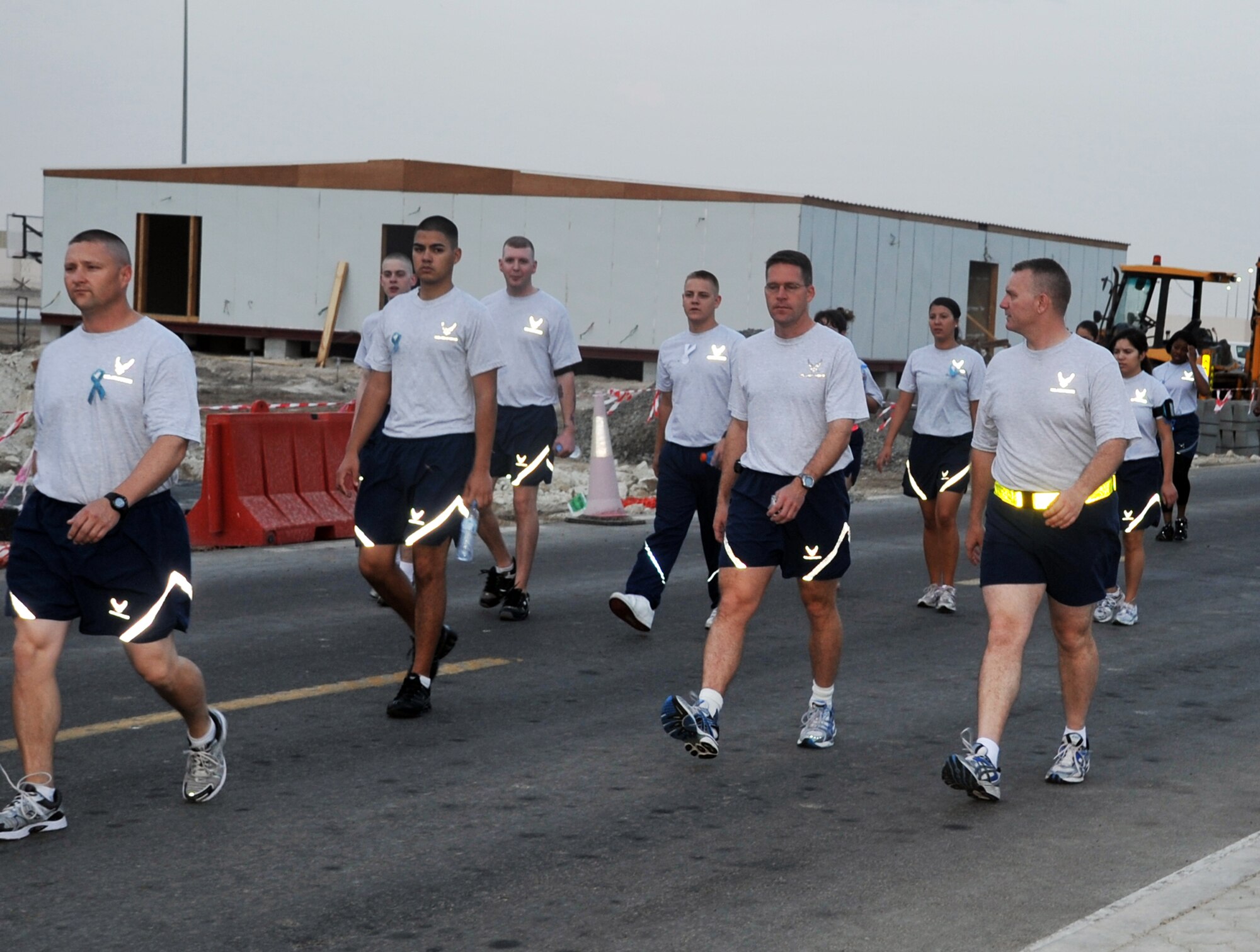 Airmen from the 380th Air Expeditionary Wing participate in the "Walk A Mile In Their Shoes" event by the 380th Air Expeditionary Wing at a non-disclosed base in Southwest Asia on April, 19, 2010, in observance of Sexual Assault Awareness Month. Throughout a one-mile walk, signs with information on sexual assault were placed while walk participants read them and walked in silence. The event was organized by Capt. Richard Laca -- the 380th AEW sexual assault response coordinator. (U.S. Air Force Photo/Master Sgt. Scott T. Sturkol/Released)