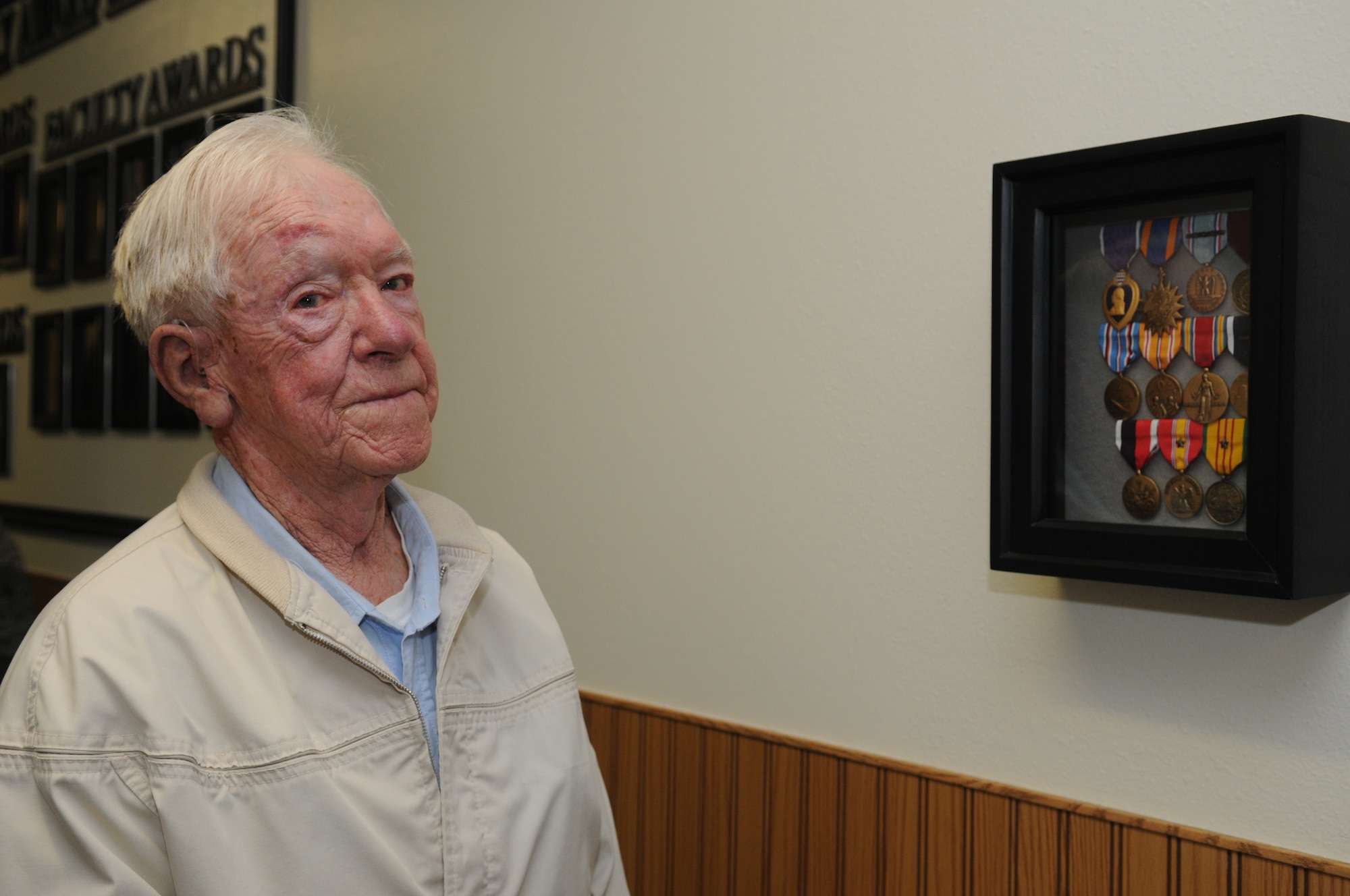 GOODFELLOW AIR FORCE BASE, Texas -- Robert Sebers, brother of Tech. Sgt. Fred Sebers, stands next to his brother's shadow box, April 15, 2010. Robert Sebers came to Goodfellow to visit the building dedicated to his brother. Sergeant Sebers was killed in 1967 while assigned to Det. 1, 6994th Security Squadron, Nha Trang, Republic of Vietnam. (U.S. Air Force photo/Airman 1st Class Clayton Lenhardt)