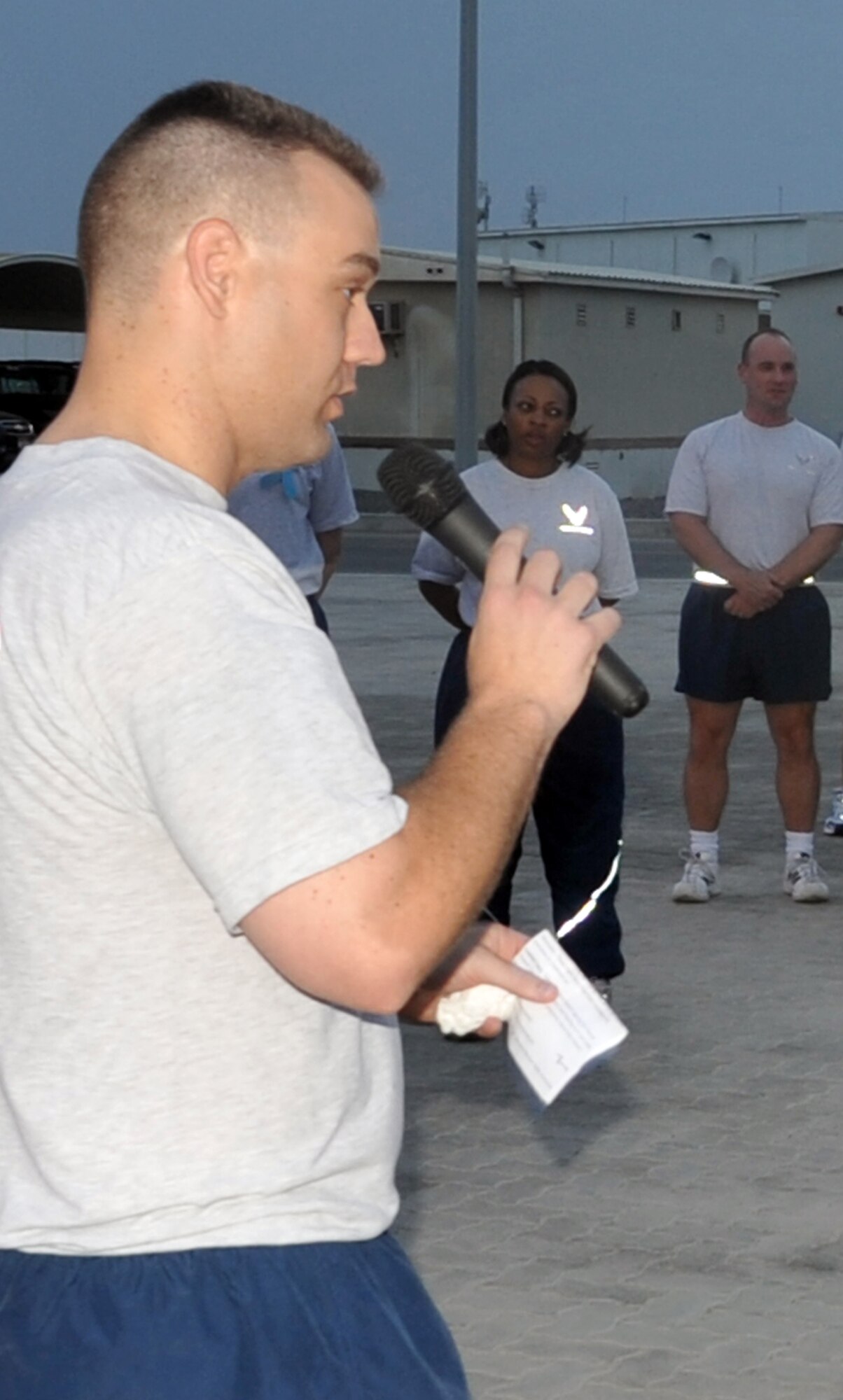 Capt. Richard Laca, 380th Air Expeditionary Wing sexual assault response coordinator, talks to the attendees to the "Walk A Mile In Their Shoes" event put on by the 380th Air Expeditionary Wing in observance of Sexual Assault Awareness Month at a non-disclosed base in Southwest Asia on April 19, 2010. Captain Laca is deployed from Eielson Air Force Base, Alaska. (U.S. Air Force Photo/Master Sgt. Scott T. Sturkol/Released)