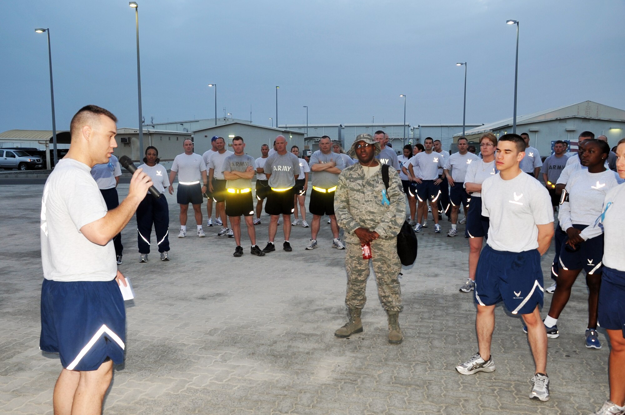 Capt. Richard Laca, 380th Air Expeditionary Wing sexual assault response coordinator, talks to the attendees to the "Walk A Mile In Their Shoes" event put on by the 380th Air Expeditionary Wing in observance of Sexual Assault Awareness Month at a non-disclosed base in Southwest Asia on April 19, 2010. Captain Laca is deployed from Eielson Air Force Base, Alaska. (U.S. Air Force Photo/Master Sgt. Scott T. Sturkol/Released)