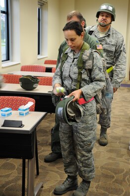 Airmen from the 927th Air Refueling Wing are issued reflective belts for a mobility exercise at MacDill Air Force Base, Fla., April 20, 2010. The exercise is the first of many scheduled over the course of the year in preparation for an Operational Readiness Inspection slated for January 2011. (U.S. Air Force photo by Senior Airman Anna-Marie Wyant)