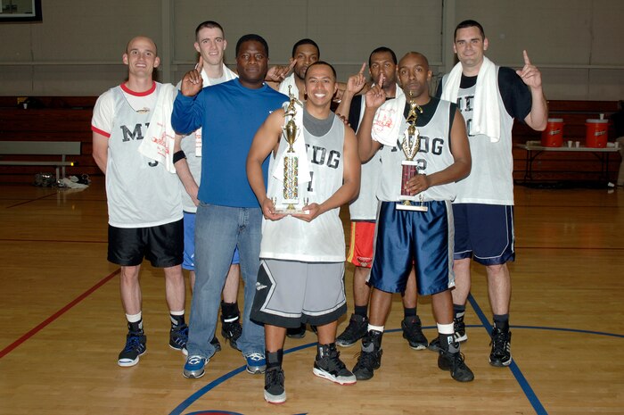 The 628th Medical Group basketball team celebrates their victory with the base trophy at the end of the base intramural basketball championship game held at the Fitness and Sports Center April 16, 2010, at Joint Base Charleston, S.C. The 628 MDG defeated the 437th Maintenance Squadron 38-32 for the top spot. The team finished the season with an undefeated 13-0 record. (U.S. Air Force photo/Staff Sgt. Marie Brown)