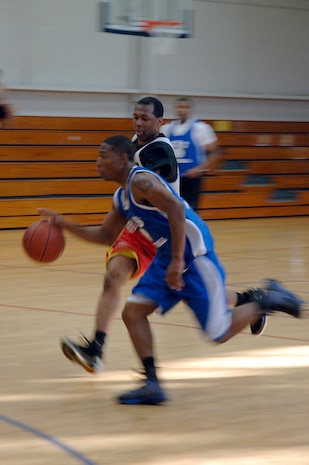 Cervante Harris, back, tries to stop Rosevelt Badgett from running the ball down the court during the base intramural basketball championship game held at the Fitness and Sports Center April 16, 2010, at Joint Base Charleston, S.C. The 628th Medical Group defeated the 437th Maintenance Squadron 38-32 for the base championship. Harris is assigned to the 628 MDG, and Badgett is assigned to the 437 MXS. (U.S. Air Force photo/Staff Sgt. Marie Brown)