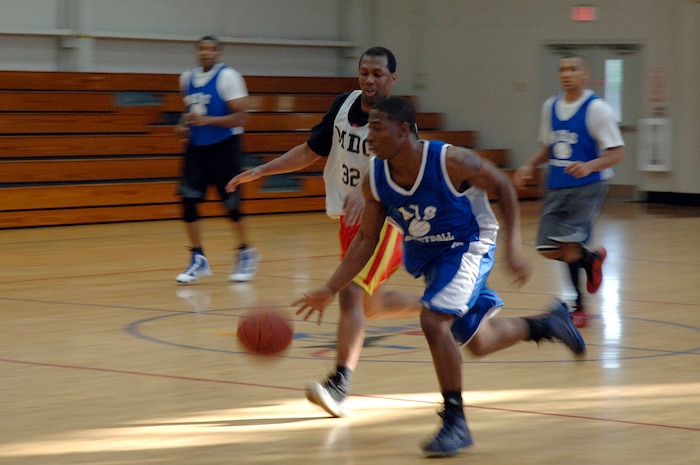 Cervante Harris, back, tries to stop Rosevelt Badgett from running the ball down the court during the base intramural basketball championship game held at the Fitness and Sports Center April 16, 2010, at Joint Base Charleston, S.C. The 628th Medical Group defeated the 437th Maintenance Squadron 38-32 for the base championship. Harris is assigned to the 628 MDG, and Badgett is assigned to the 437 MXS. (U.S. Air Force photo/Staff Sgt. Marie Brown)