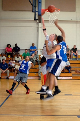 Matthew Everette, back, and Nigel Brown, front, fight for a rebound during the base intramural basketball championship game held at the Fitness and Sports Center April 16, 2010 at Joint Base Charleston, S.C. With less than five minutes left in the game, the 628th Medical Group trailed 437th Maintenance Squadron 30-31, but pushed hard in the final moments for a 38-32 win. Everette is assigned to the 628 MDG, and Brown is assigned to the 437 MXS. (U.S. Air Force photo/Staff Sgt. Marie Brown)