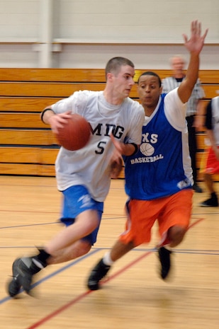 Matthew Everette, left, tries to get past Randy Crumblin's block during the base intramural basketball championship game held at the Fitness and Sports Center April 16, 2010, at Joint Base Charleston, S.C. The 628th Medical Group was awarded the first place trophy after defeating the 437th Maintenance Squadron 38-32. Everette is assigned to the 628 MDG, and Crumblin is assigned to the 315th Maintenance Squadron. (U.S. Air Force photo/Staff Sgt. Marie Brown)