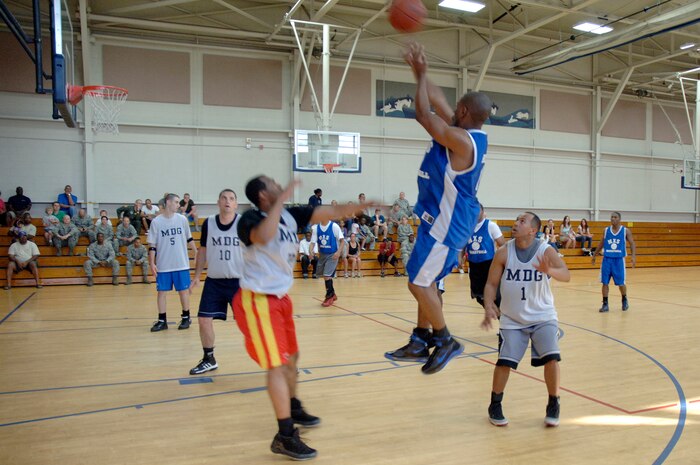 Adrian Bozeman shoots a jump shot as members of the 628th Medical Group wait for the rebound during the base intramural basketball championship game held at the Fitness and Sports Center April 16, 2010, at Joint Base Charleston, S.C. Bozeman was pivotal in the first half for the 437 MXS with several three-point shots, aiding his team toward a 16-point lead. Bozeman is assigned to the 437 MXS. (U.S. Air Force photo/Staff Sgt. Marie Brown)