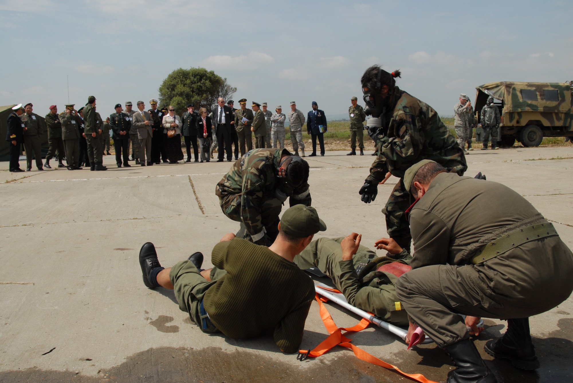 U.S. Ambassador to the Republic of Tunisia, Gordon Gray, Maj. Gen. Edward L. Wright, adjutant general for Wyoming, and members of the Wyoming legislature, along with Tunisian and American military members, observe patient retrieval during exercise MEDLITE-10 at Kharrouba Air Base, Tunisia. Tunisian and American medical personnel are working together to hone their medical and chemical contamination treatment techniques. (USAF Photo by Master Sgt. Paul Mann/Released) 