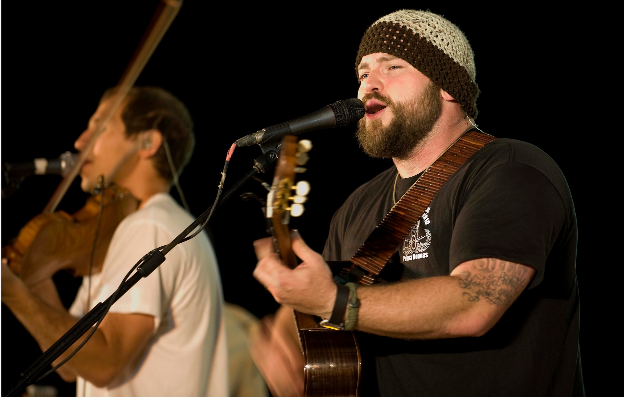 Zac Brown and his band perform for a crowd of deployed personnel in Holt Stadium at Joint Base Balad, Iraq, April 18, 2010. The Grammy nominated band is touring various bases throughout Southwest Asia to perform for the troops rather than attend this year's Academy of Country Music Awards for which they were nominated. (U.S. Air Force photo by Master Sgt. Linda C. Miller/Released)
