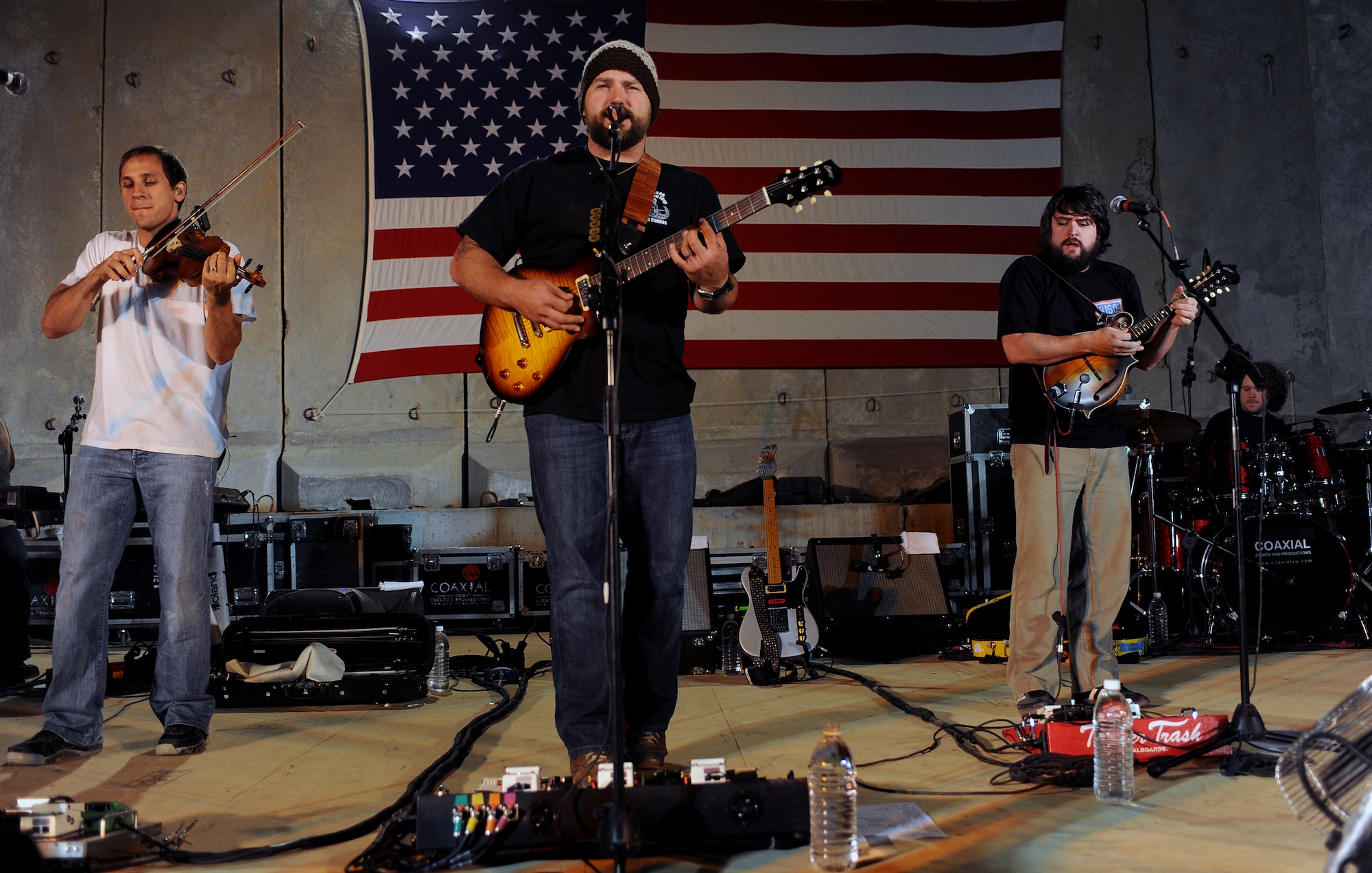 Members of the Zac Brown Band perform for a crowd of deployed personnel at Holt Stadium at Joint Base Balad, Iraq, April 18, 2010. The Grammy-nominated band is touring various bases throughout Southwest Asia to perform for the troops rather than attend this year's Academy of Country Music Awards for which they were nominated for several awards. (U.S. Air Force photo by Master Sgt. Linda C. Miller/Released)