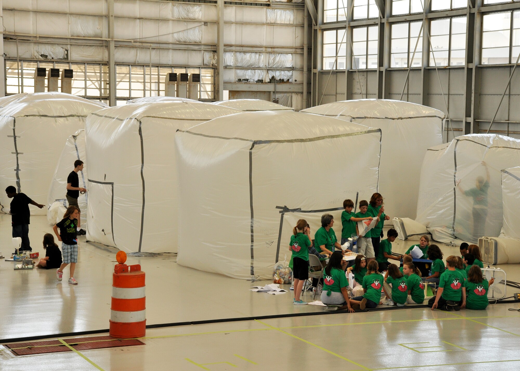 Students from Walker Elementary School (black) and Valparaiso Elementary School (green) work out plans to build the Mars pod living units at Eglin Air Force Base April 16.  More than 120 students from Wright, Longwood and Valparaiso elementary schools gathered on Eglin for a single mission: build a life-sustaining pod on Mars.   The 15th annual Marsville event is a collaborative effort between Eglin and the surrounding community's elementary school fifth-grade students, and faculty members. One of its top goals is to encourage students to pursue careers in science and engineering.  (U.S. Air Force photo/Staff Sgt. Stacia Zachary.)