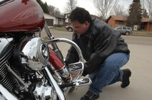 MINOT, N.D. -- Rod Krause, 5th Bomb Wing ground safety manger, checks his tire pressure prior to taking a ride into town on his motorcycle here April 18. Minot Airmen should perform routine checks on their motorcycles to ensure safe operations and an enjoyable ride. (U.S. Air Force photo by Senior Airman Michael J. Veloz)