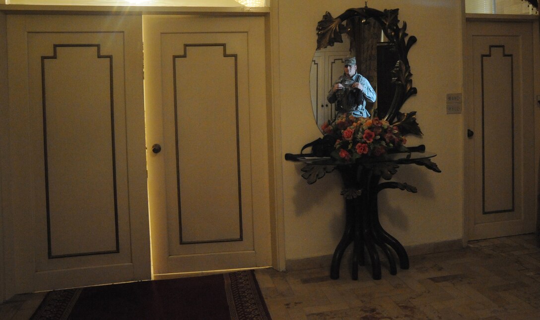Air Force Tech. Sgt. Matt Loiselle, Personal Security Advisor for the Air Component Coordination Element Director, keeps a watchful eye over the door where the general is meeting a local official in Baghdad, Iraq, March 24, 2010. Sergeant Loiselle has been in charge of three teams consisting of 40 Army personnel, who were deployed from locations such as the Kentucky and Tennessee Army National Guard units and he trained them to be part of this team.  (U.S. Air Force photo/Master Sgt. Trish Bunting/Released)