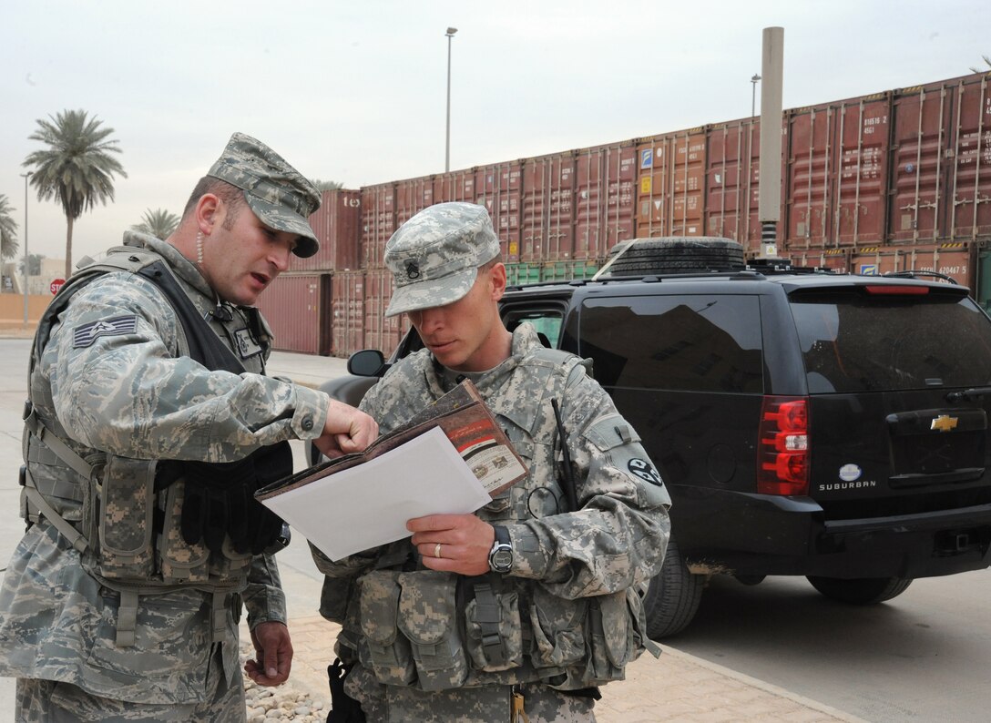 Air Force Tech. Sgt. Matt Loiselle, Personal Security Advisor for the Air Component Coordination Element Director, discusses transportation information with a member of the personal security detail while inside the U.S. Embassy compound, Baghdad, Iraq, March 24, 2010. Sergeant Loiselle has been in charge of three teams consisting of 40 Army personnel, who were deployed from locations such as the Kentucky and Tennessee Army National Guard units and he trained them to be part of this team.  (U.S. Air Force photo/Master Sgt. Trish Bunting/Released)