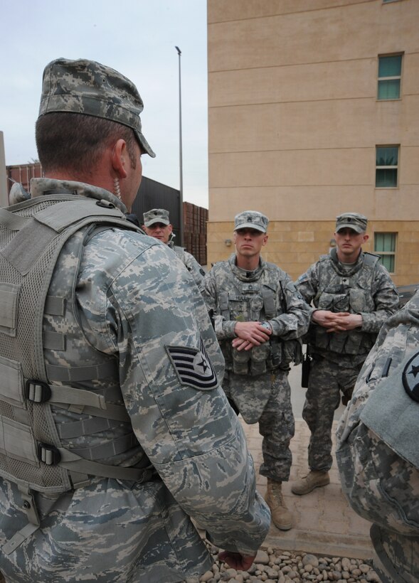 Air Force Tech. Sgt. Matt Loiselle, Personal Security Advisor for the Air Component Coordination Element Director, discusses transportation information with members of the personal security detail while inside the U.S. Embassy compound, Baghdad, Iraq, March 24, 2010. Sergeant Loiselle has been in charge of three teams consisting of 40 Army personnel, who were deployed from locations such as the Kentucky and Tennessee Army National Guard units and he trained them to be part of this team.  (U.S. Air Force photo/Master Sgt. Trish Bunting/Released)