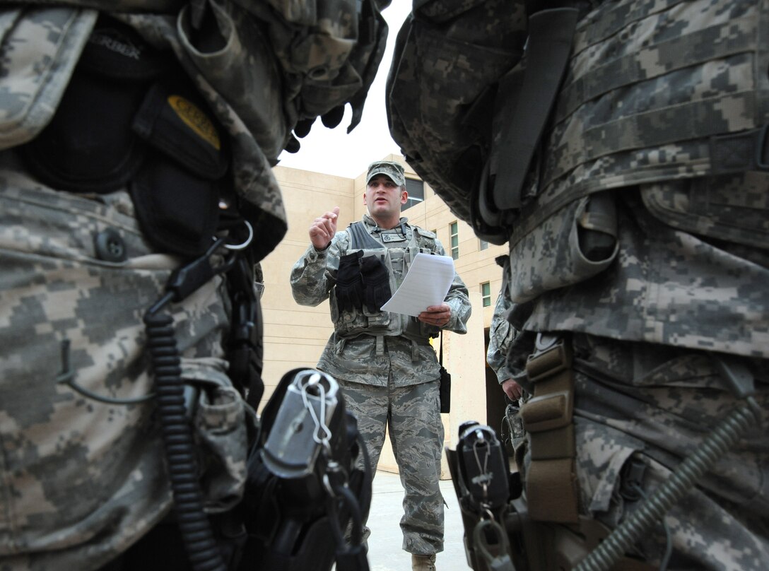 Air Force Tech. Sgt. Matt Loiselle, Personal Security Advisor for the Air Component Coordination Element Director, discusses transportation information with members from the personal security detail while inside the U.S. Embassy compound, Baghdad, Iraq, March 24, 2010. Sergeant Loiselle has been in charge of three teams consisting of 40 Army personnel, who were deployed from locations such as the Kentucky and Tennessee Army National Guard units and he trained them to be part of this team.  (U.S. Air Force photo/Master Sgt. Trish Bunting/Released)