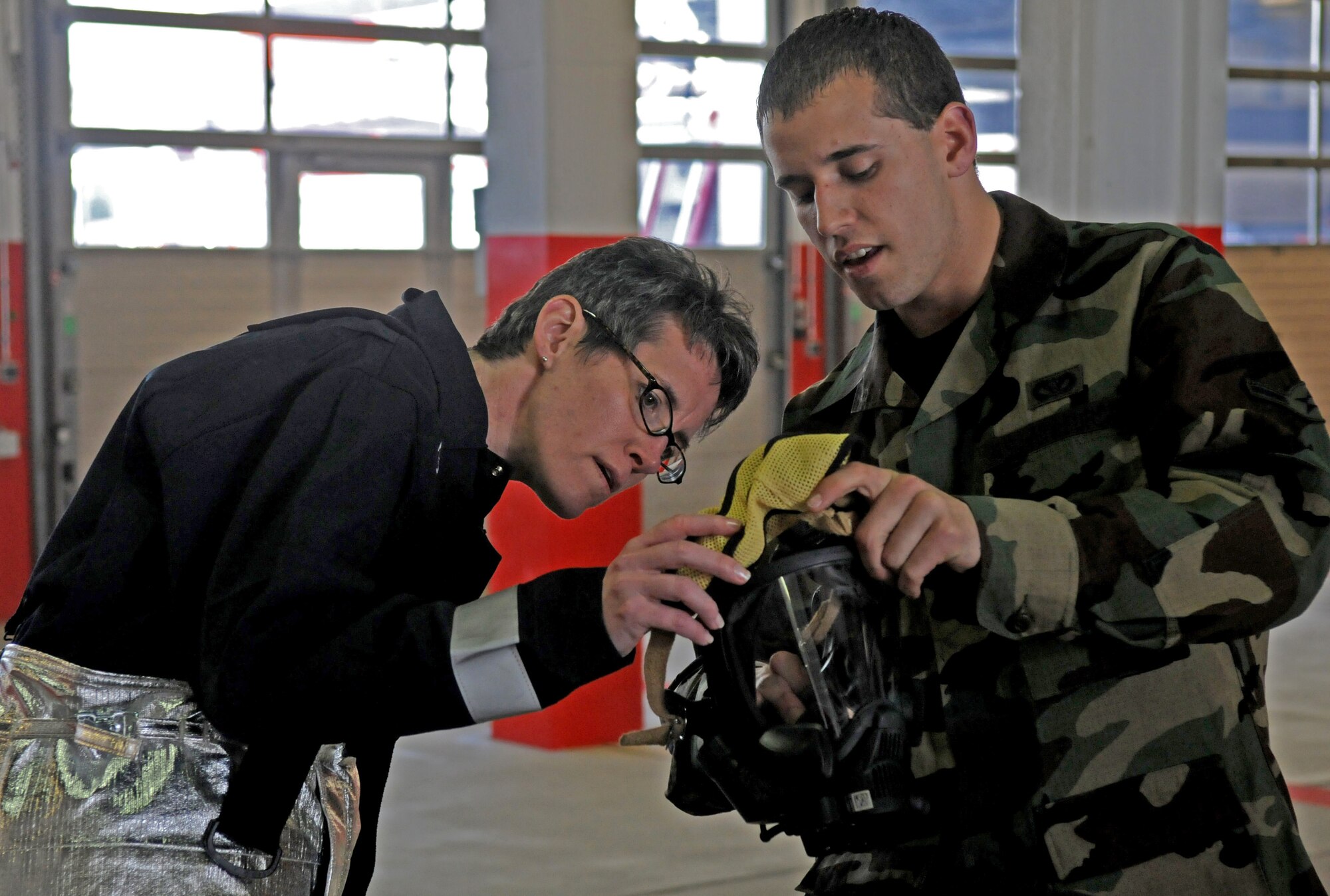 SPANGDAHLEM AIR BASE, Germany – Col. Jodine Tooke, left, 52nd Mission Support Group commander, learns about the Firehawk M7 Air Mask from Airman Joseph Farsetta, 52nd Civil Engineer Squadron firefighter, April 16. The 52nd CES firefighters led Colonel Tooke through numerous firefighting exercises to provide first-hand experience. (U.S. Air Force photo/Airman 1st Class Staci Miller)