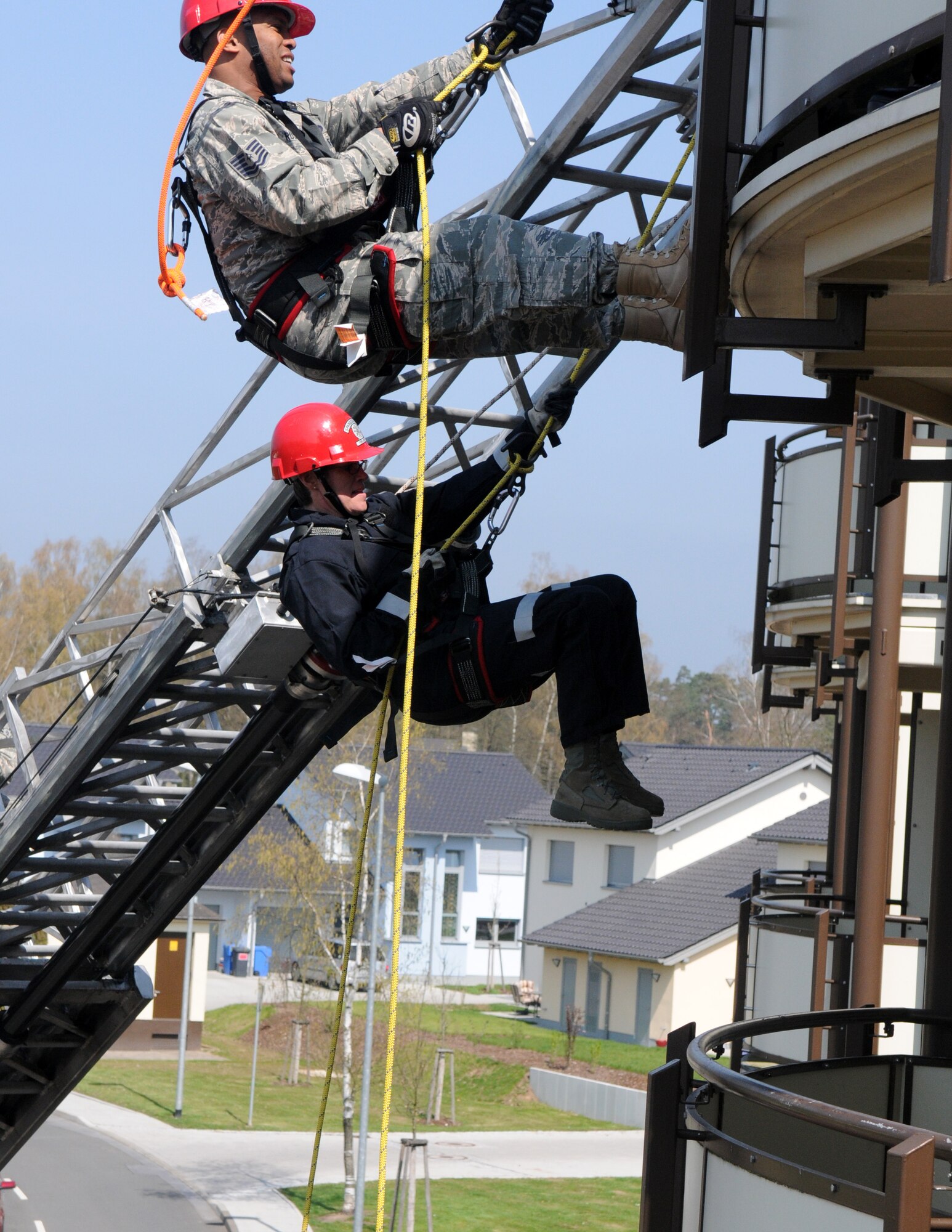 SPANGDAHLEM AIR BASE, Germany – Col. Jodine Tooke, bottom, 52nd Mission Support Group commander, participates in a repelling exercise with Tech. Sgt. Shanton Russel, 52nd Civil Engineer Squadron firefighter, April 16. The 52nd Civil Engineer Squadron firefighters led Colonel Tooke through numerous firefighting exercises to provide first-hand experience. (U.S. Air Force photo/Airman 1st Class Staci Miller)