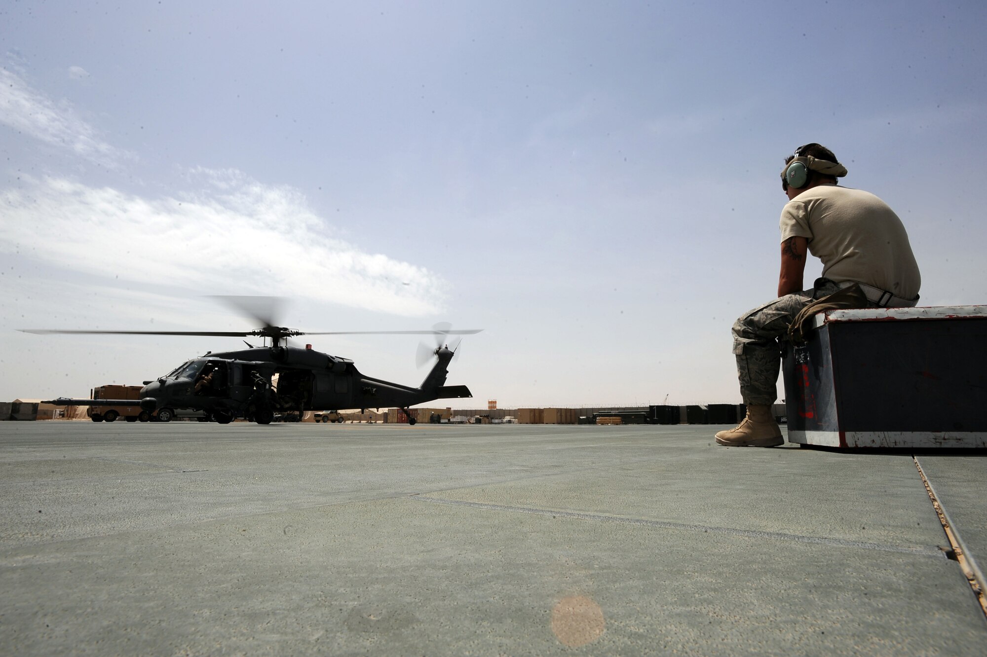 Staff Sgt. Mathew Reihle, an HH-60G Pave Hawk crew chief assigned to the 451st Expeditionary Aircraft Maintenance Squadron helicopter maintenance unit, watches an HH-60G helicopter to take-off for an alert mission, April, 16, 2010, at Camp Bastion, Afghanistan. (U.S. Air Force photo/Staff Sgt. Manuel J. Martinez/released)