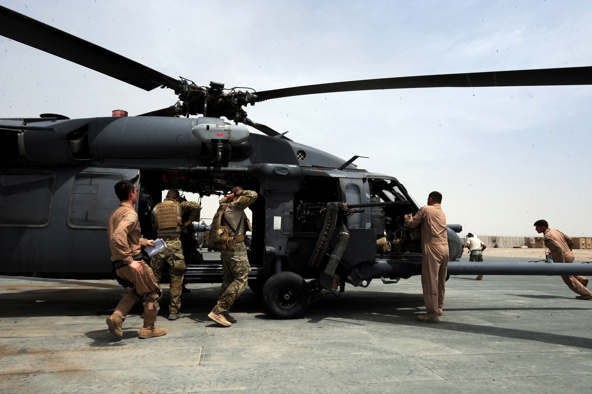 An HH-60G Pave hawk aircrew and pararescuemen, assigned to the 41st Expeditionary Rescue Squadron, scramble to an HH-60G Pave Hawk to respond to an alert call, April 16, 2010, Camp Bastion, Afghanistan. ?If it was not for maintenance and support Airmen, the aircrews and ?Guardian Angel? team could not fly to recover wounded military and local nationals,? said Maj. John Graver, 41st ERQS combat-rescue officer deployed from the 304th Rescue Squadron in Portland, Ore. ?We all work here together as a team, in which everyone plays a vital role in the motto ??That Others May Live?. These HH-60G helicopter maintainers show extreme pride in keeping the helos flying, during a very high operations tempo in a very harsh environment.? (U.S. Air Force photo/Staff Sgt. Manuel J. Martinez/released)