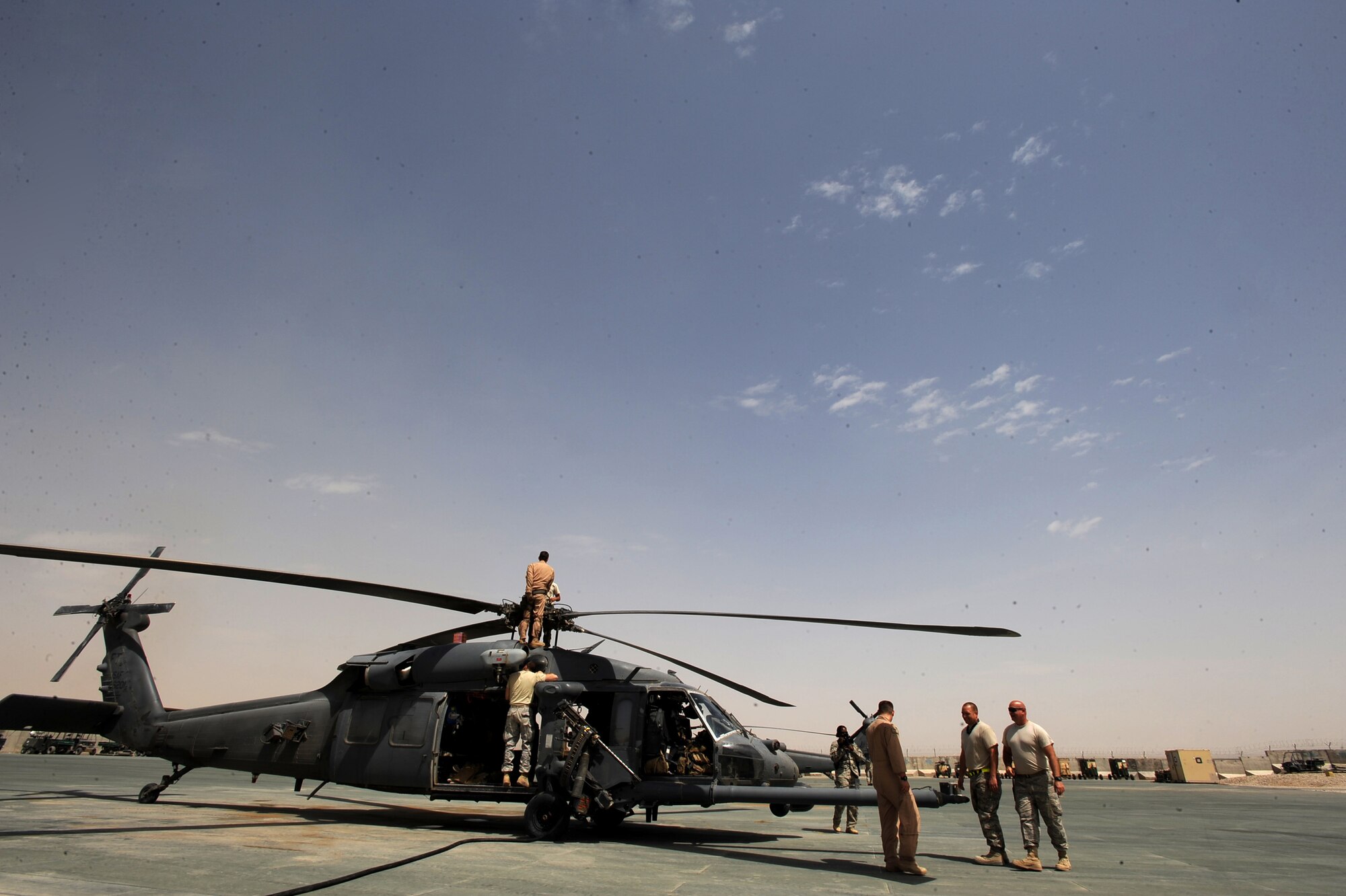 Aircraft maintenance Airmen assigned to the 451st Expeditionary Aircraft Maintenance Squadron helicopter maintenance unit and an HH-60G Pave Hawk flight engineer assigned to the 41st Expeditionary Rescue Squadron, perform minor maintenance on an HH-60G Pave Hawk after the aircrew returned from a medical-evacuation mission April 16, 2010, at Camp Bastion, Afghanistan. Flying at a utilization rate of three to four times more than home station, HMU Airmen are conducting 50-hour inspections, that take place every month and a half stateside, every week and a half in Afghanistan. (U.S. Air Force photo/Staff Sgt. Manuel J. Martinez/released)