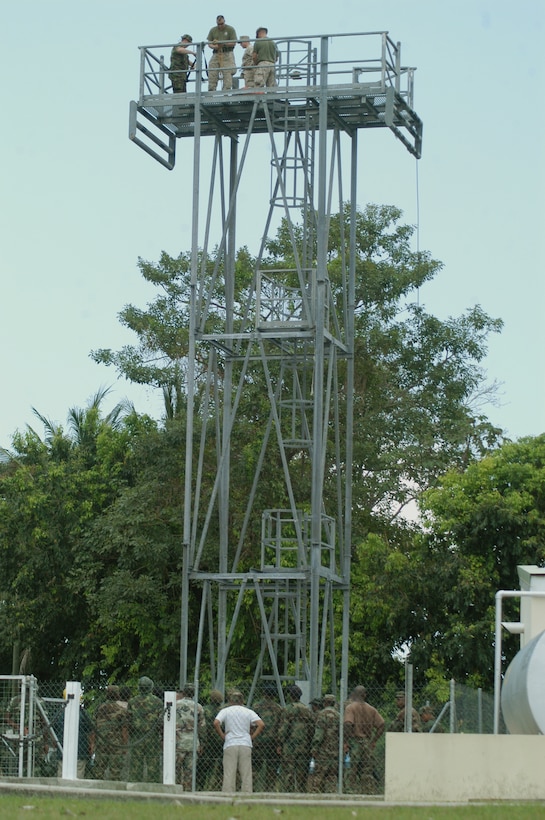Price Barracks, Belize (April 20, 2010) – Caribbean Partner Nation Soldiers observe a rapelling tower standing 45 ft. tall during confined space rescue operations training instructed by Hazardous Materials Environmental Services Department Marine Forces Reserve Marines as part of Tradewinds 2010, a U.S. Southern Command sponsored annual exercise that is conducted with Caribbean Basin partner nations, designed to improve cooperation with the partner nations in responding to regional security threats. (Official USMC photo by Lance Cpl. Lucas Vega)