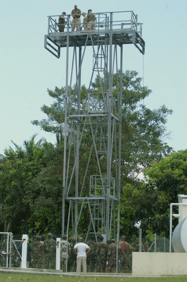 Price Barracks, Belize (April 20, 2010) – Caribbean Partner Nation Soldiers observe a rapelling tower standing 45 ft. tall during confined space rescue operations training instructed by Hazardous Materials Environmental Services Department Marine Forces Reserve Marines as part of Tradewinds 2010, a U.S. Southern Command sponsored annual exercise that is conducted with Caribbean Basin partner nations, designed to improve cooperation with the partner nations in responding to regional security threats. (Official USMC photo by Lance Cpl. Lucas Vega)