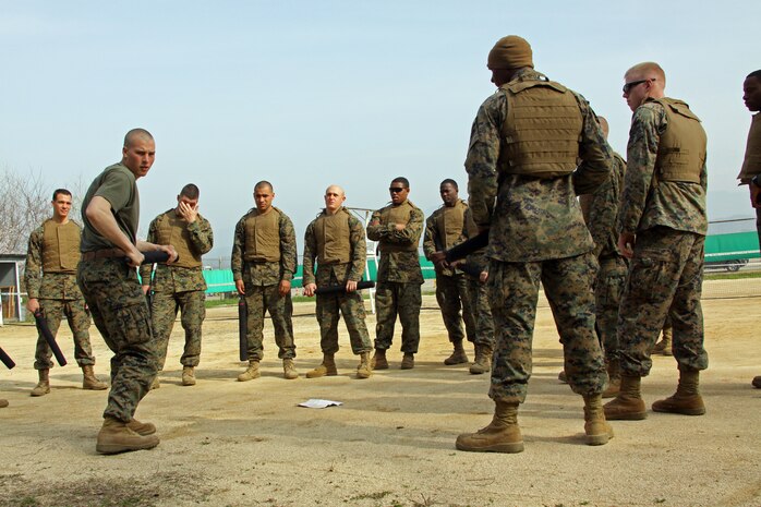 Sgt. Curtis A. Krueger, data chief with Combat Logistics Company 36 of Marine Corps Air Station Iwakuni, Japan, instructs Marines on baton techniques during a Marine Corps Martial Arts Program course April 20.