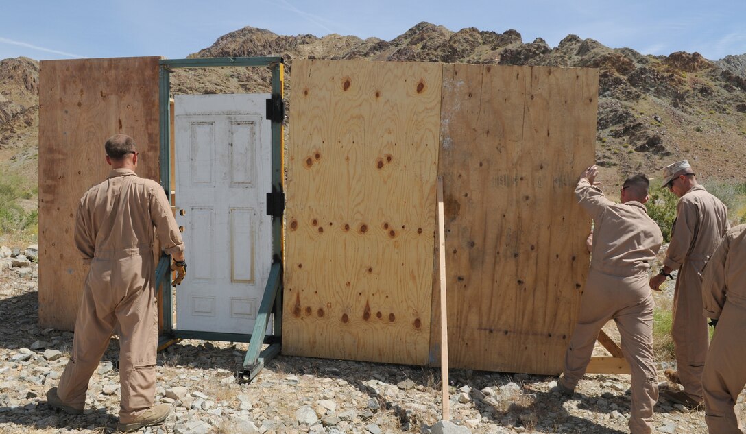 Members of the Marine Wing Support Squadron 373 explosive ordnance disposal team build a structure for breach training at Camp Billy Machen in California, April 20, 2010. The team trained with breaching charges for an upcoming deployment to Afghanistan. The team stayed in Yuma due to the air station’s proximity to the ranges and to train with MWSS-371 and station EOD teams.