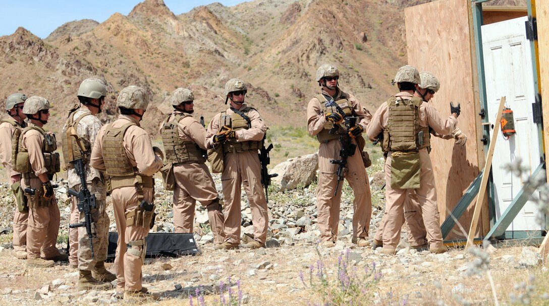 Members of the Marine Wing Support Squadron 373 explosive ordnance disposal team listen to Warrant Officer Kent Crawley, MWSS-373 EOD officer in charge, as he explains breaching tactics during training at Camp Billy Machen in California, April 20, 2010. The team trained with breaching charges for an upcoming deployment to Afghanistan. The team stayed in Yuma due to the air station’s proximity to the ranges and to train with MWSS-371 and station EOD teams. Master Gunnery Sgt. Carl Holden, MWSS-371 EOD staff noncommissioned officer in charge and a former close-quarters battle instructor for Marine Special Operations Command, taught the Marines the advanced rifle and pistol techniques he used to teach to force reconnaissance Marines.