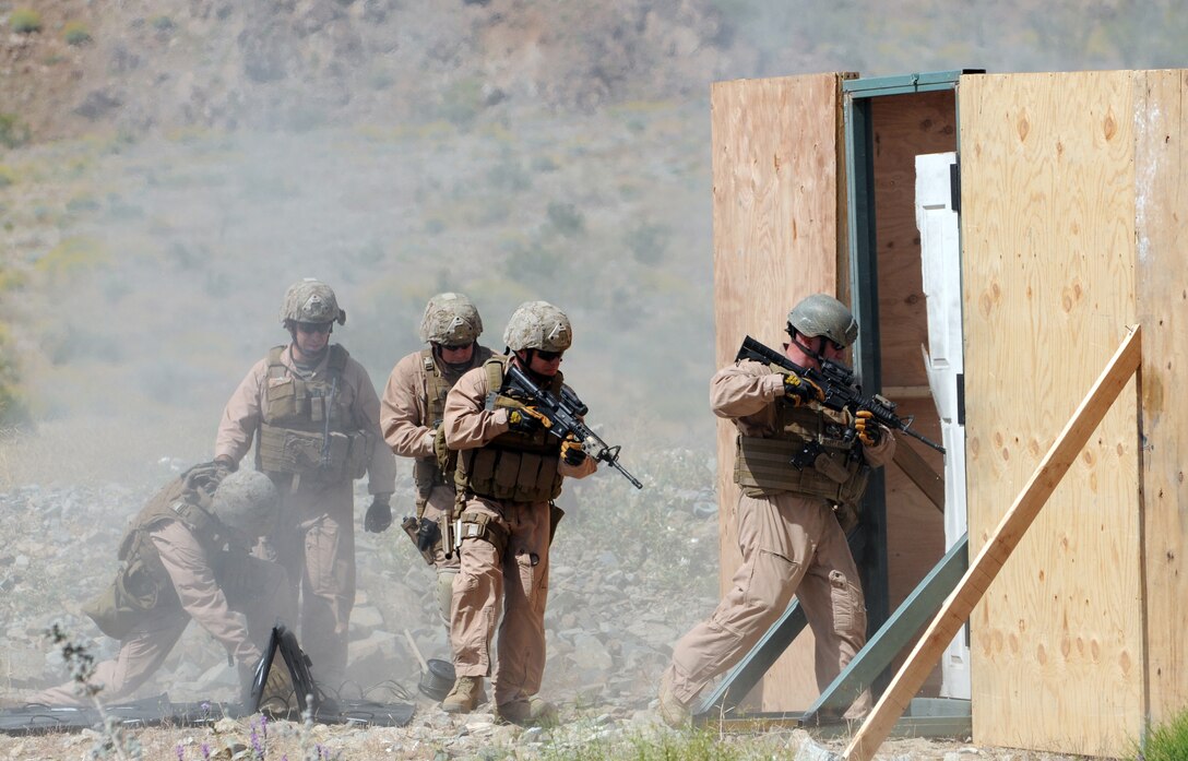 After detonating a breaching charge, members of the Marine Wing Support Squadron 373 explosive ordnance disposal team cautiously enter a structure they built for the training. The team trained with breaching charges for an upcoming deployment to Afghanistan. The team stayed in Yuma due to the air station’s proximity to the ranges and to train with MWSS-371 and station EOD teams. Master Gunnery Sgt. Carl Holden, MWSS-371 EOD staff noncommissioned officer in charge and a former close-quarters battle instructor for Marine Special Operations Command, taught the Marines the advanced rifle and pistol techniques he used to teach to force reconnaissance Marines.
